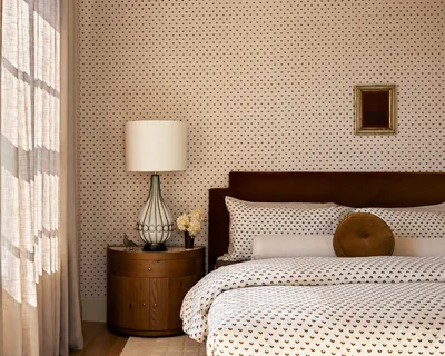 a bedroom with a bed and a lamp