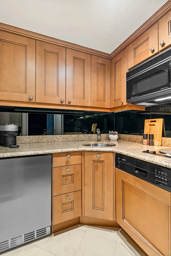a kitchen with stainless steel appliances granite countertop a sink and cabinets