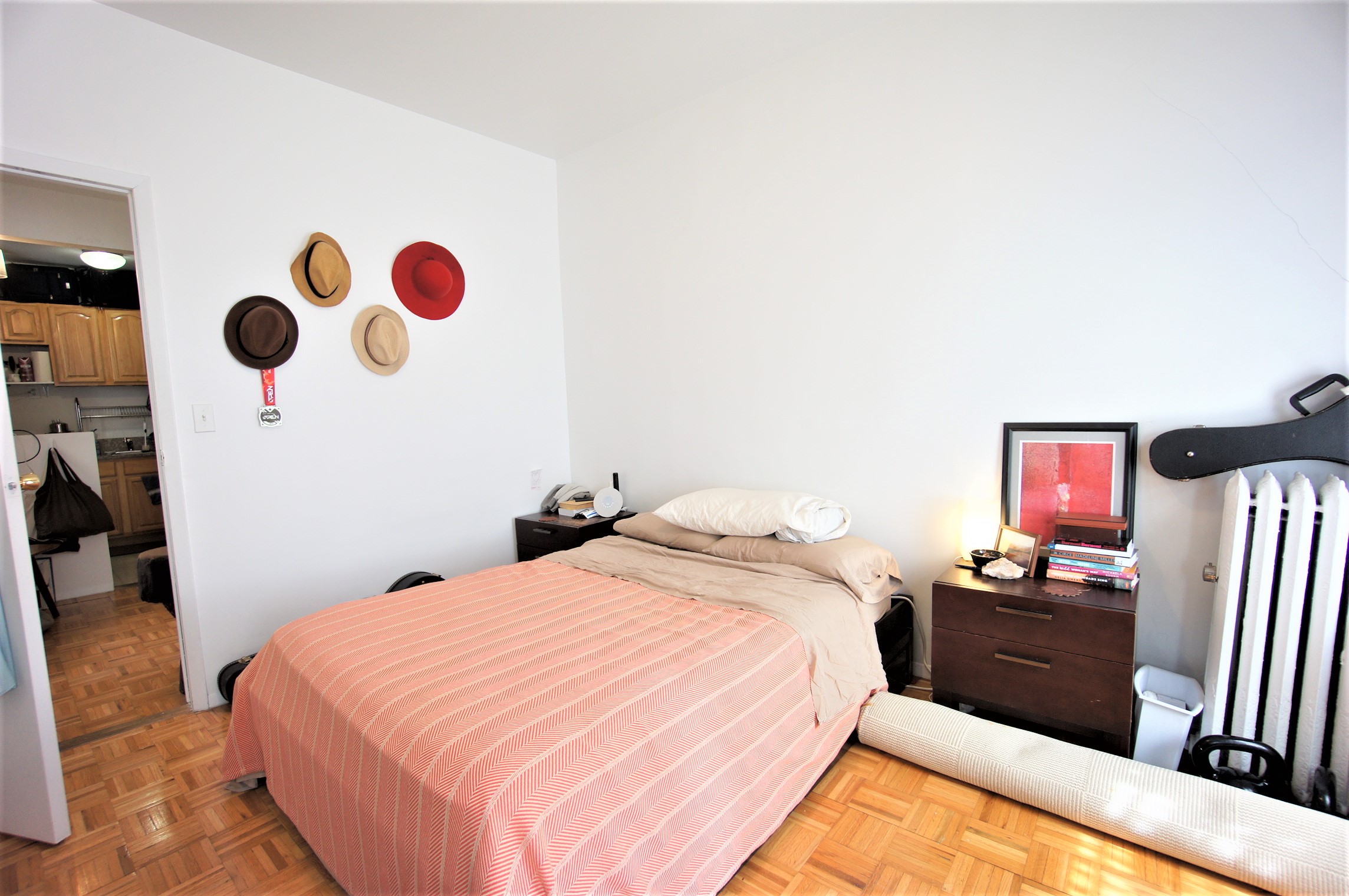 330 West 43rd Street, Unit 15 Manhattan, NY 10036 - Photo 6 of 7 a bedroom with a bed and a chandelier