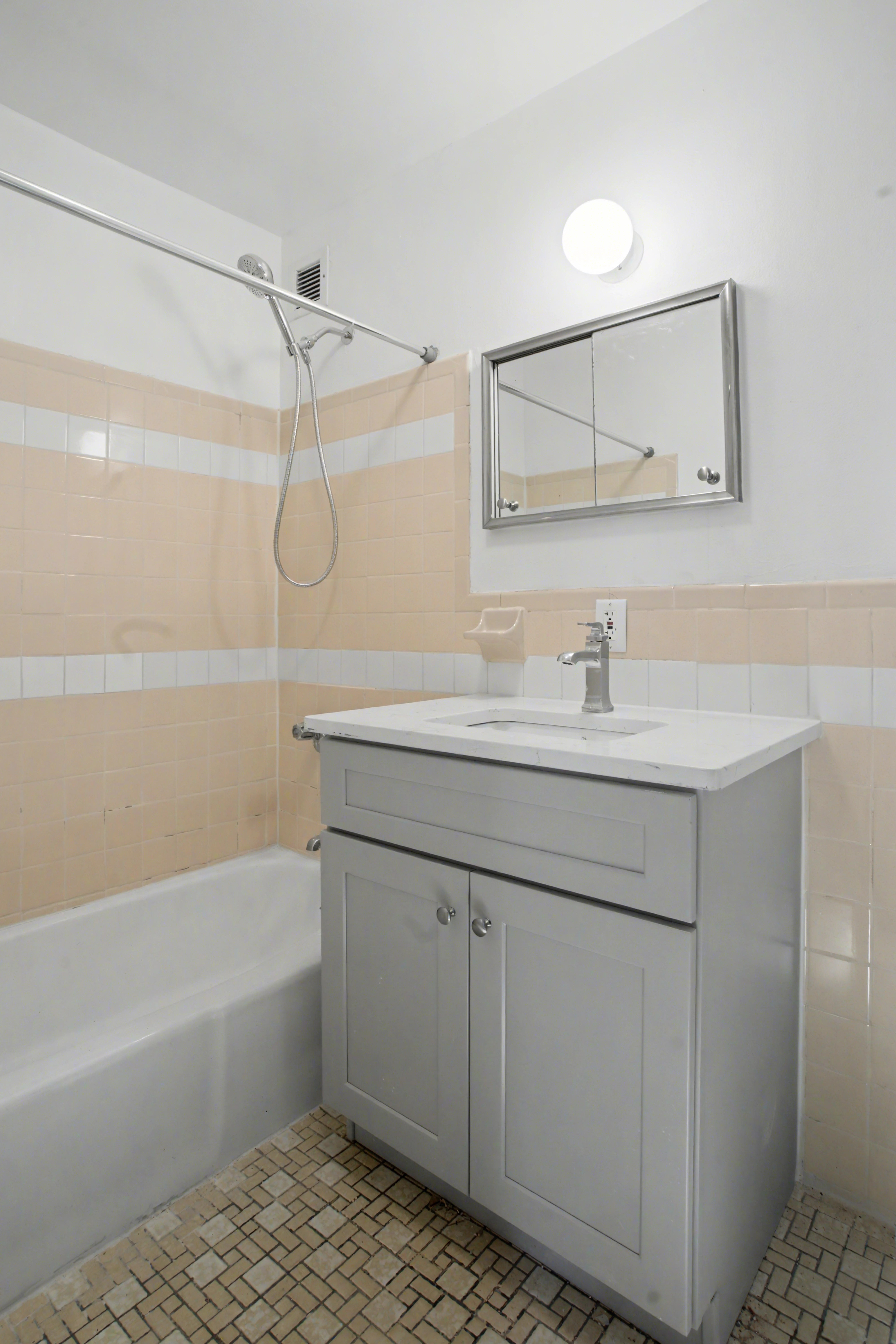 247 West 123rd Street, Unit 2F Manhattan, NY 10027 - Photo 6 of 9 a bathroom with a sink vanity granite tub shower and a mirror