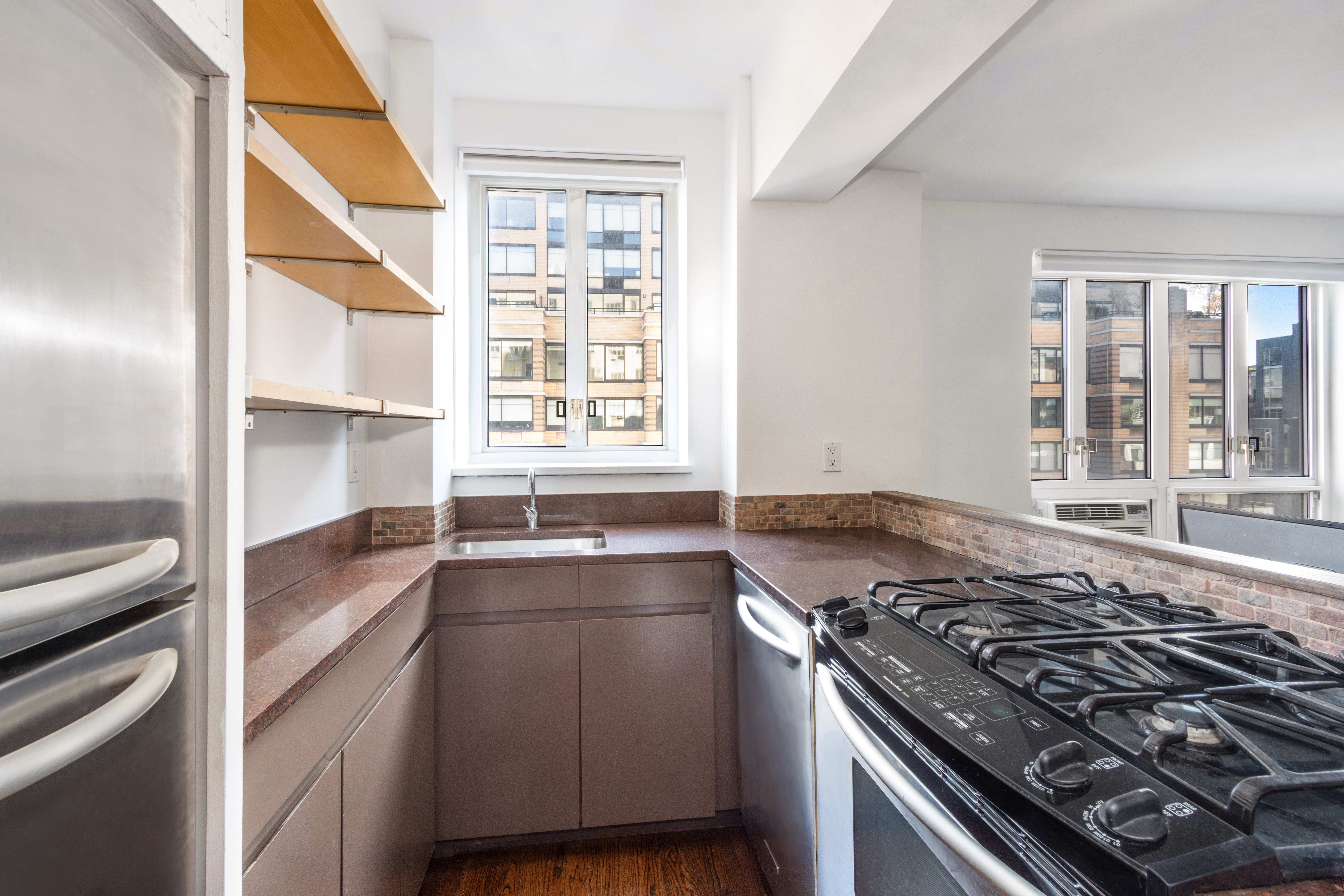 200 West 20th Street, Unit 906 Manhattan, NY 10011 - Photo 2 of 8 a kitchen with a stove and a sink