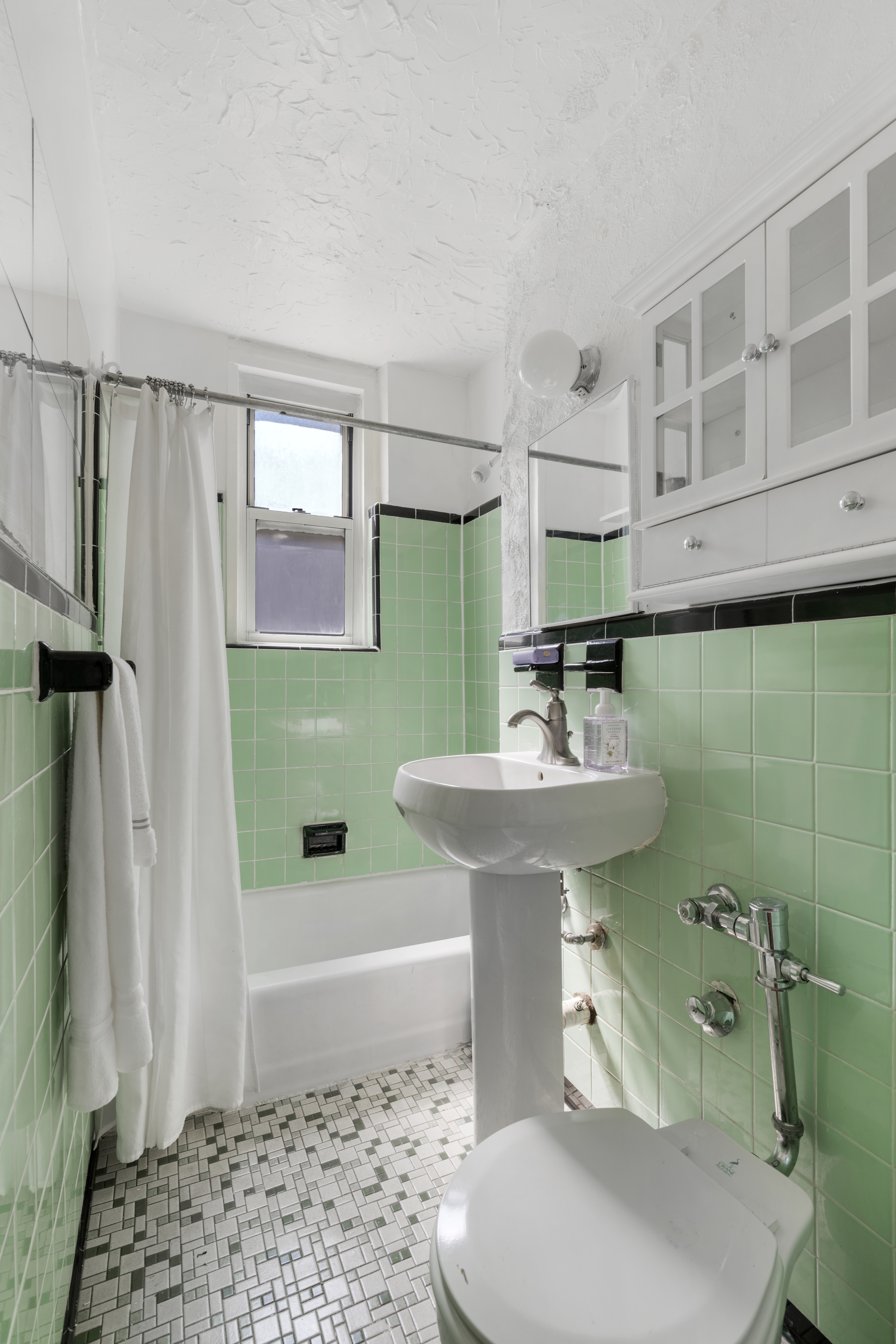 458 West 20th Street, Unit 3D Manhattan, NY 10011 - Photo 7 of 9 a bathroom with a sink a toilet and shower