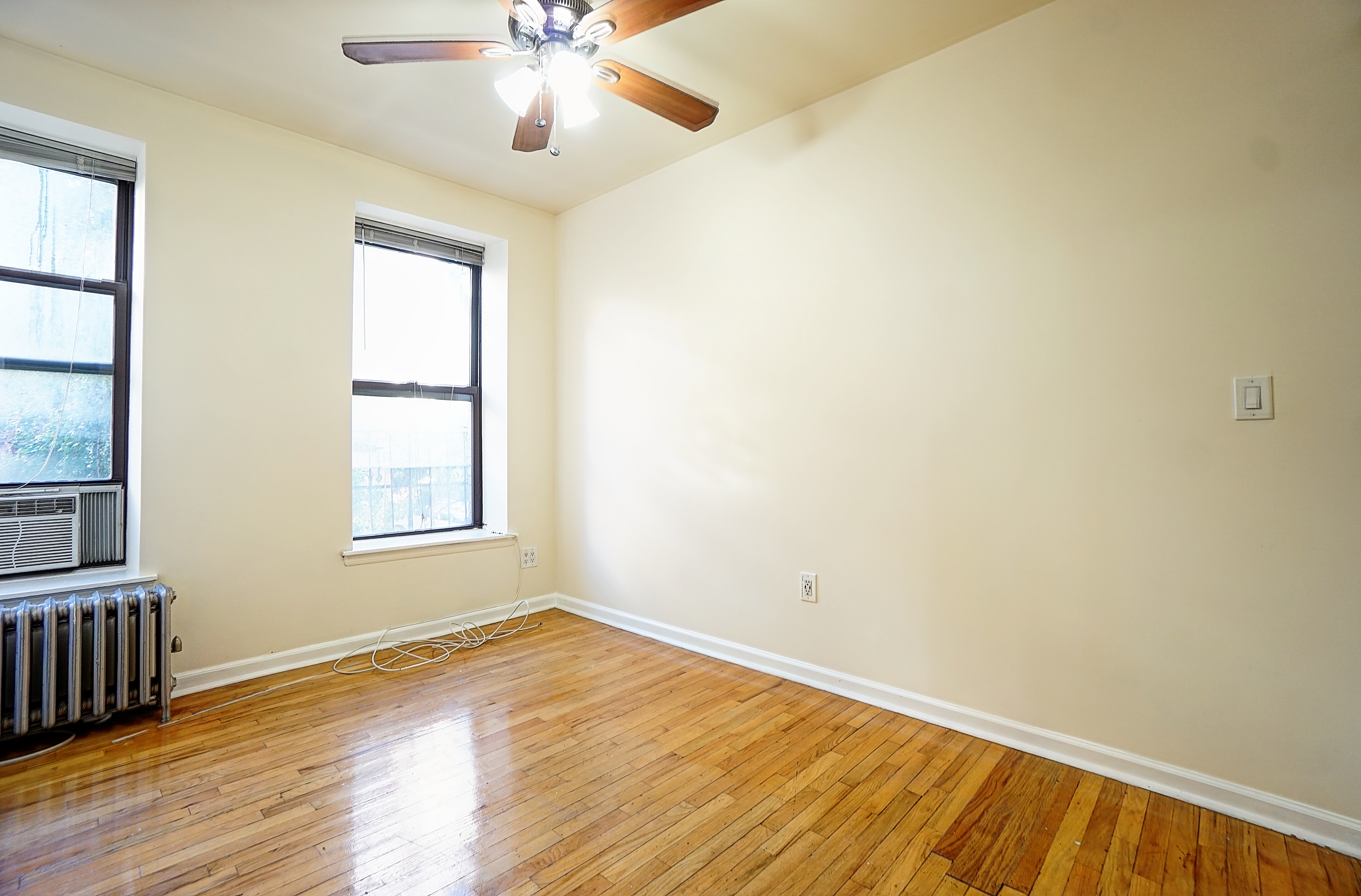 270 East 78th Street, Unit 10 Manhattan, NY 10075 - Photo 3 of 6 wooden floor in an empty room with a window