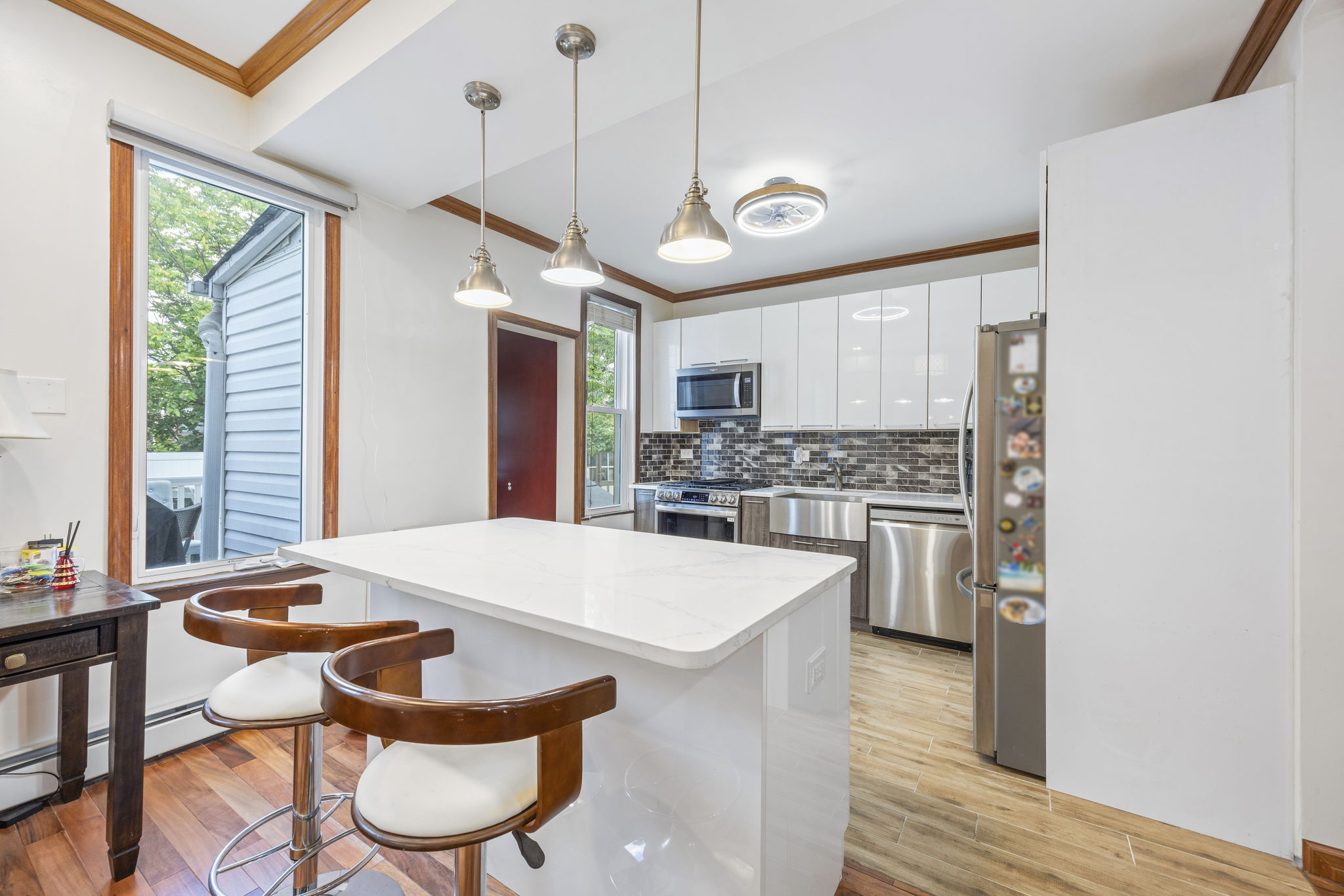 25-69 46th Street Queens, NY 11103 - Photo 20 of 33 a large kitchen with a table and chairs
