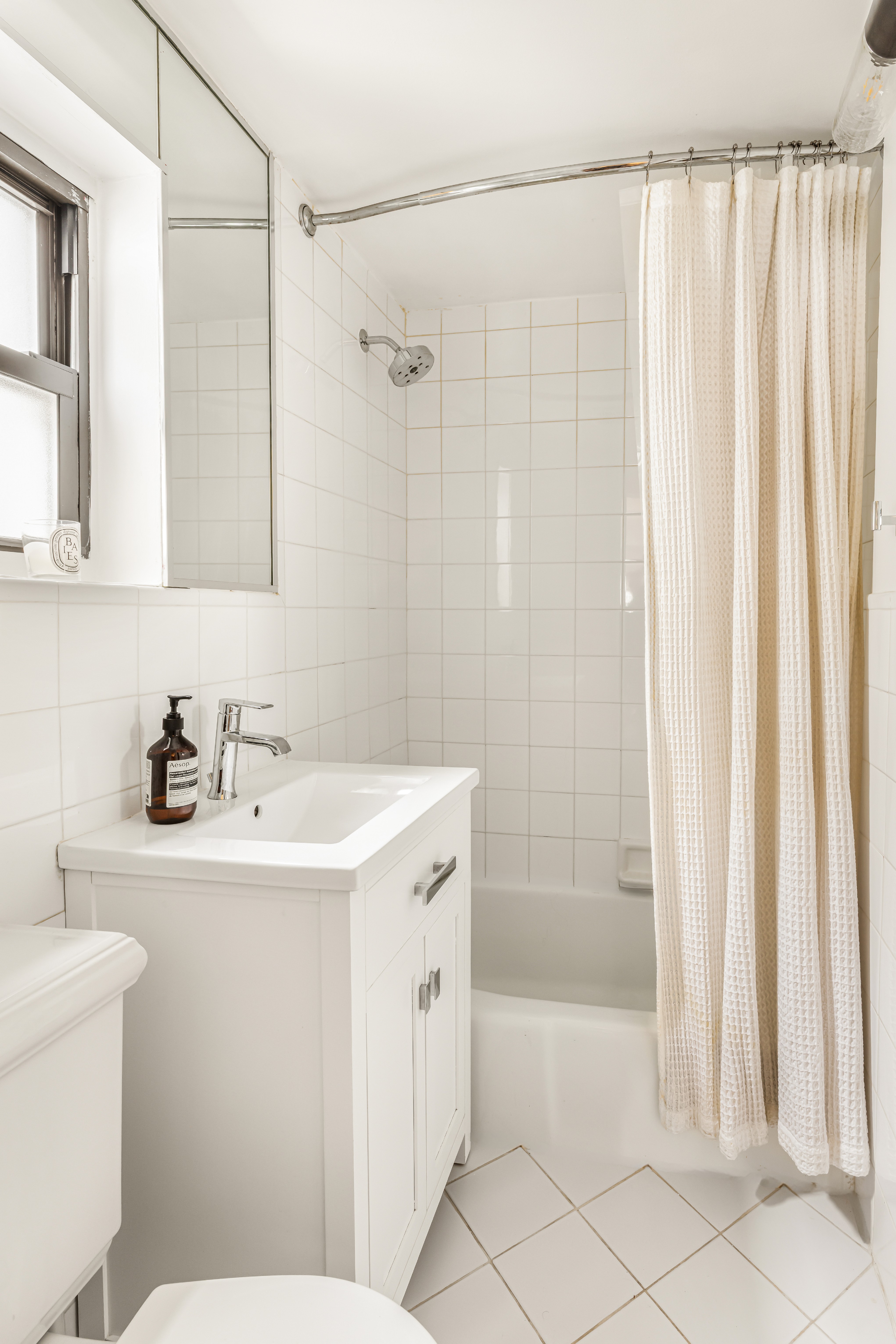 15 Jones Street, Unit 5D Manhattan, NY 10014 - Photo 5 of 7 a bathroom with a sink a toilet and shower