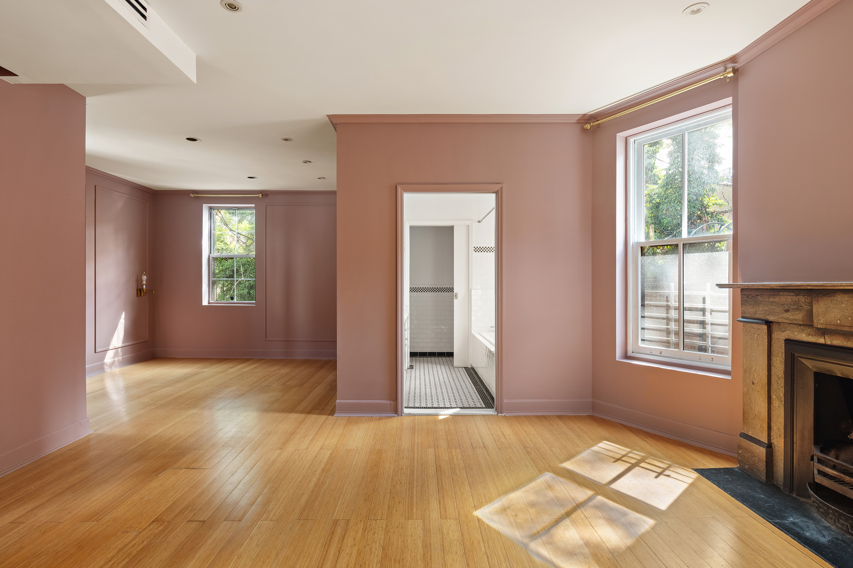 126 East 19th Street Manhattan, NY 10003 - Photo 5 of 13 an empty room with windows and fireplace
