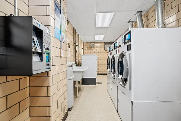 110 East 36th Street, Unit 5B Manhattan, NY 10016 - Photo 5 of 7 a utility room with dryer and washer