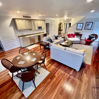 a kitchen with stainless steel appliances granite countertop a sink a stove cabinets and wooden floor