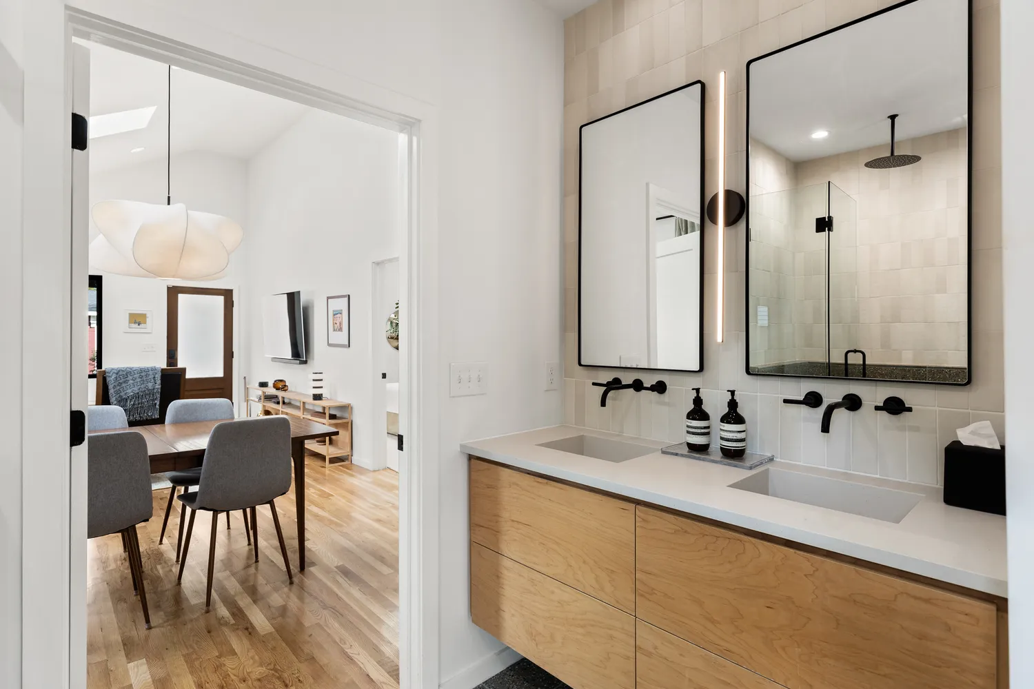 a bathroom with double vanity sinks and a mirror