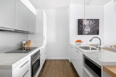 a kitchen with stainless steel appliances granite countertop a sink and a microwave