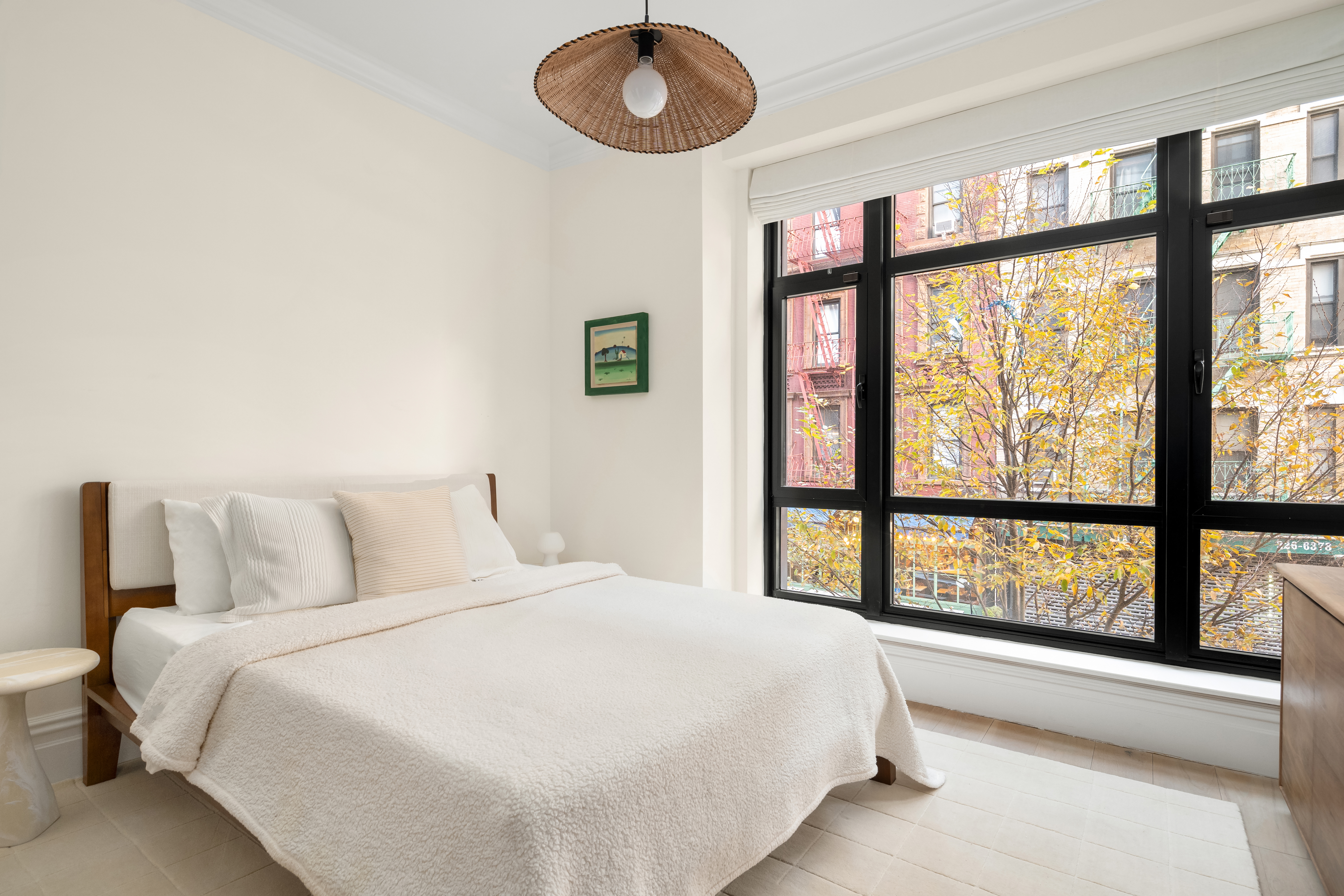 199 Mott Street, Unit 2 Manhattan, NY 10012 - Photo 13 of 14 a bedroom with a large bed and a large window