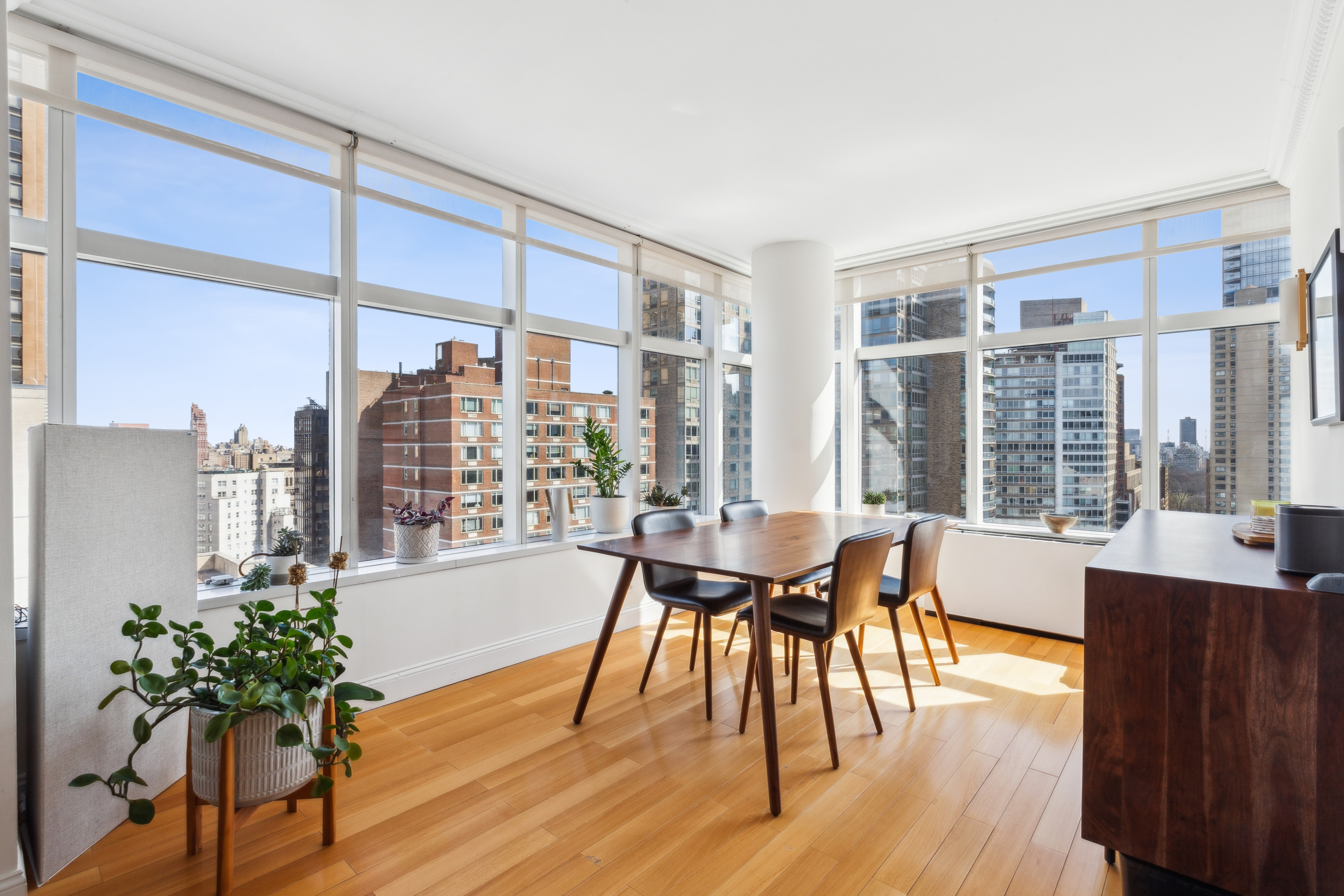 160 West 66th Street, Unit 23D Manhattan, NY 10023 - Photo 2 of 10 a dining room with furniture window and wooden floor
