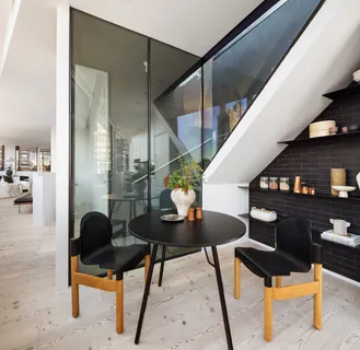 a living room with furniture and a potted plant