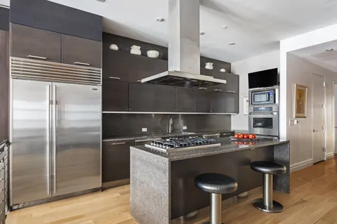 a kitchen with a refrigerator and a table