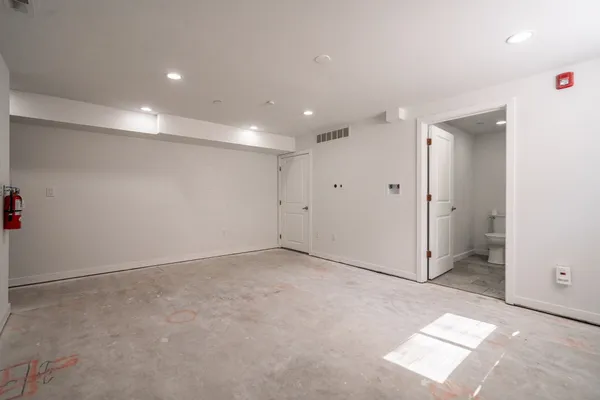 an empty room with windows and closet