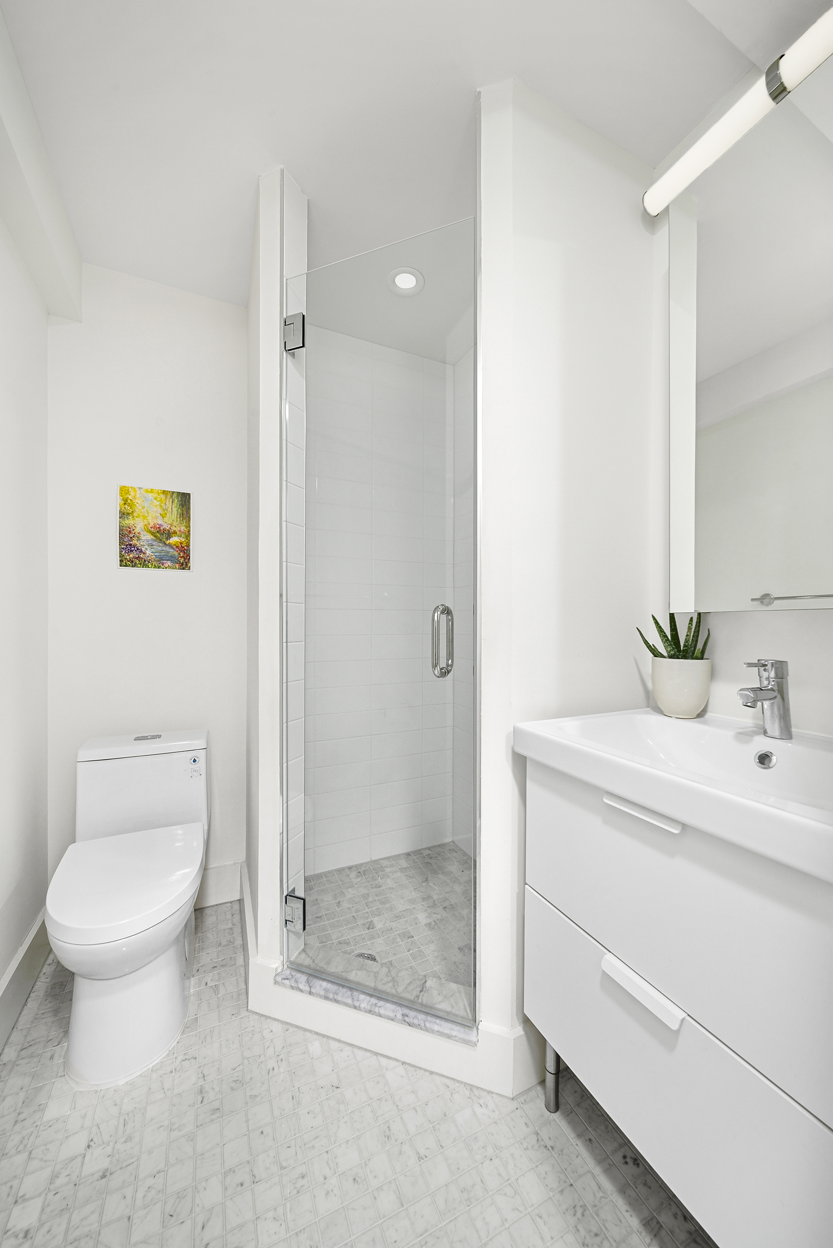 9511 Shore Road, Unit 505 Brooklyn, NY 11209 - Photo 9 of 18 a bathroom with a granite countertop sink a toilet and a shower