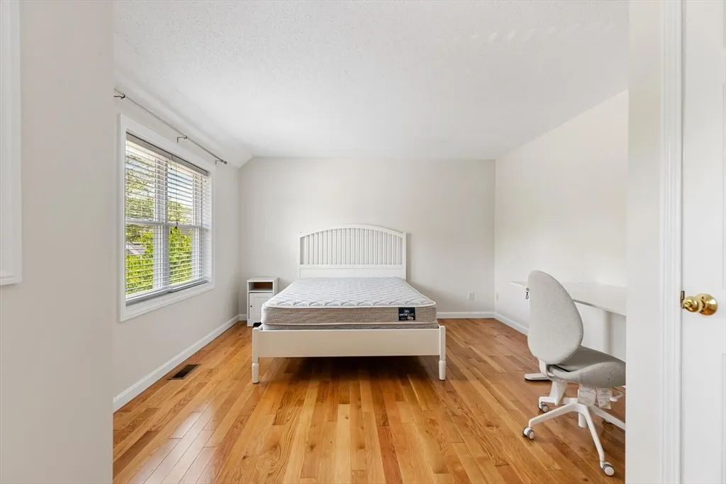 a spacious bedroom with a bed and a window