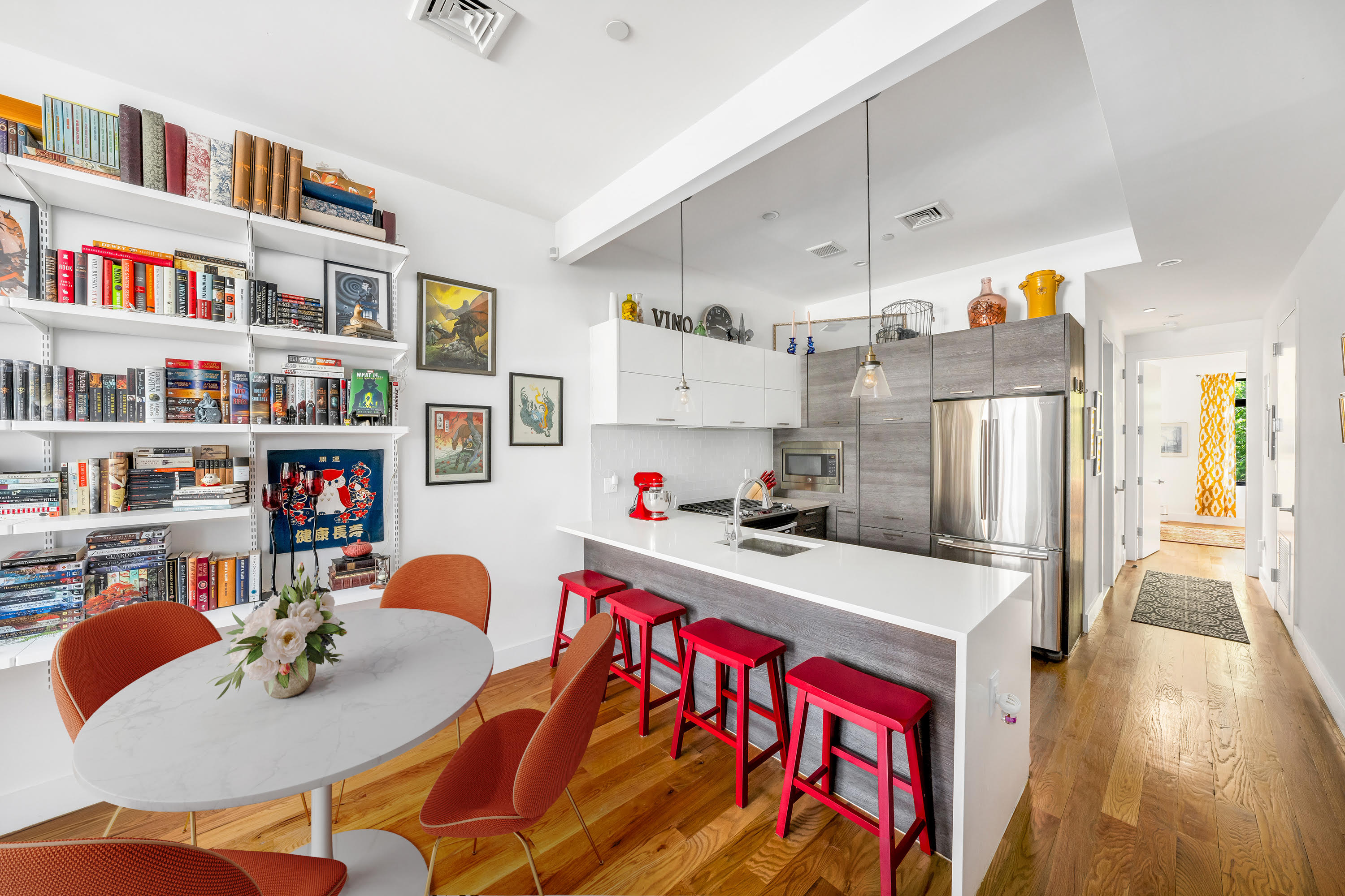 a kitchen with stainless steel appliances granite countertop a refrigerator and a dining table