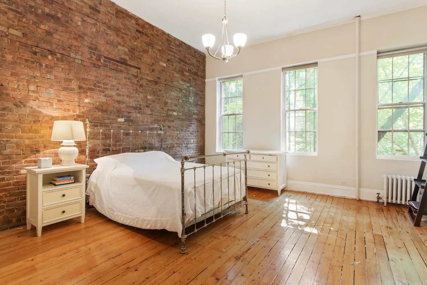 a spacious bedroom with a bed and a window