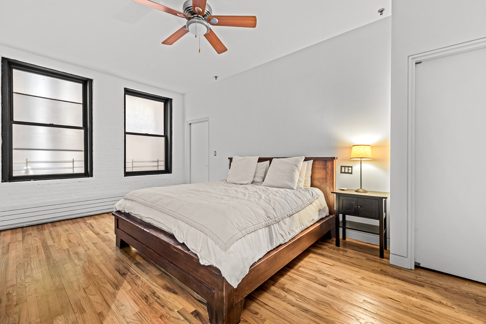 130 Watts Street, Unit 5N Manhattan, NY 10013 - Photo 4 of 11 a bedroom with a bed and a window