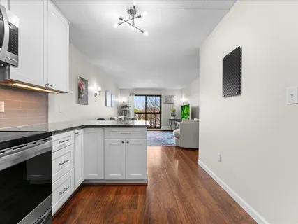 a kitchen with a refrigerator and a stove top oven