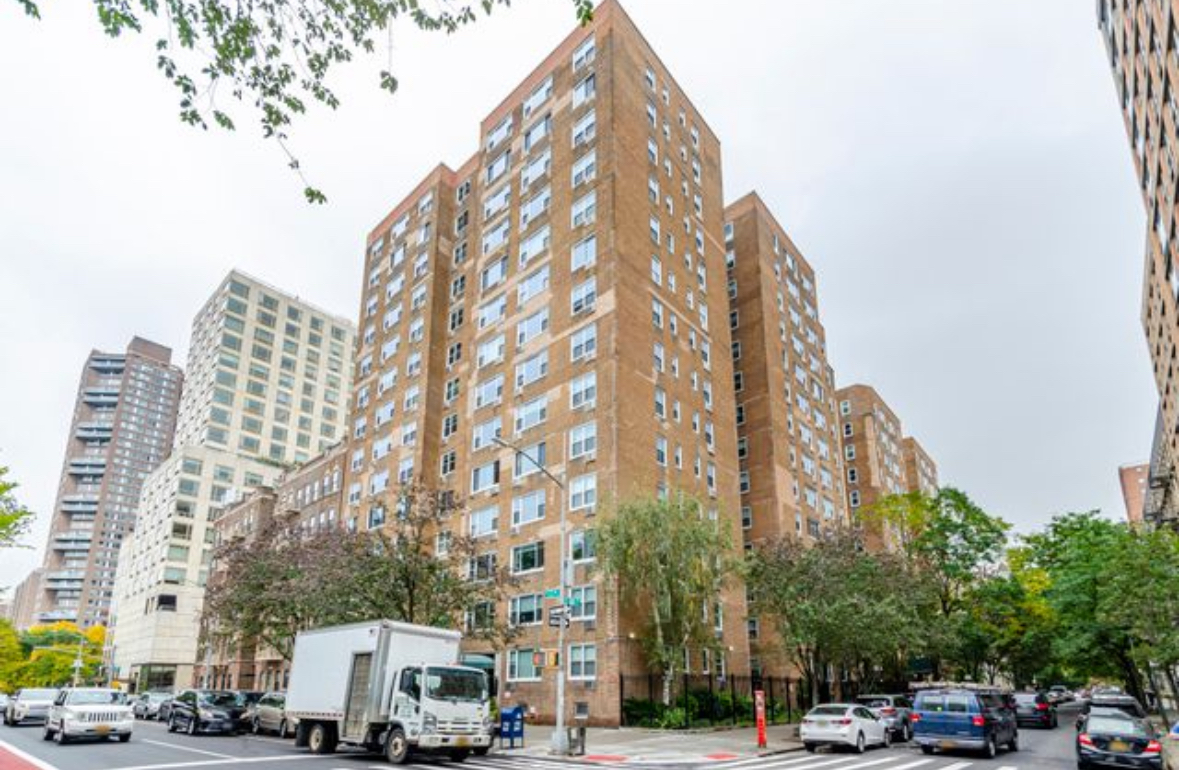 1270 5th Avenue, Unit 3B Manhattan, NY 10029 - Photo 5 of 7 a city street lined with parked cars and buildings