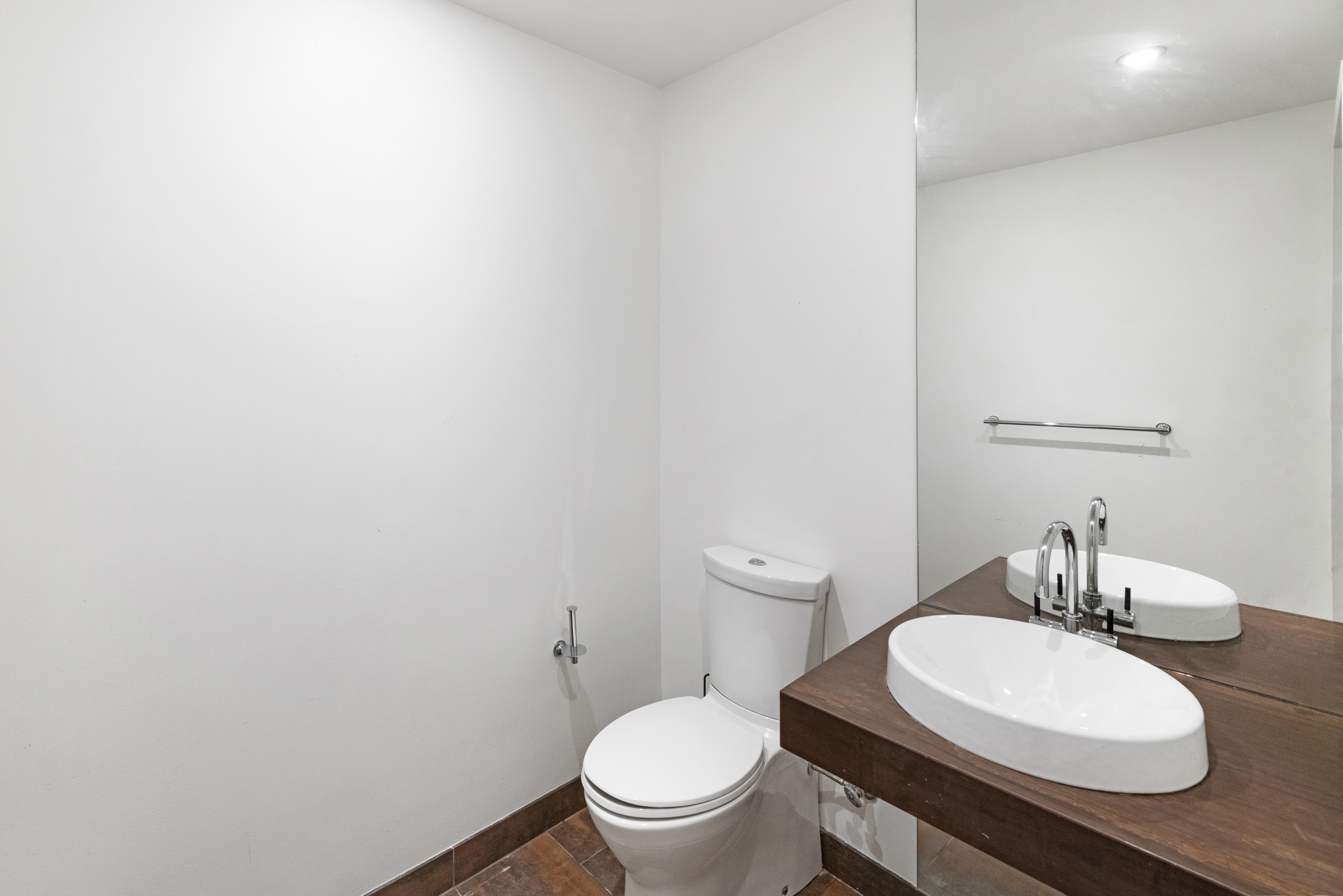 2 Northside Piers, Unit 2U Brooklyn, NY 11249 - Photo 6 of 12 a white toilet sitting next to a bathroom sink