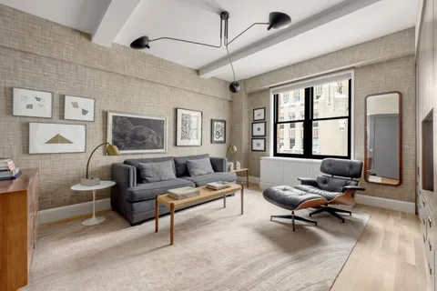 a living room with furniture rug and window