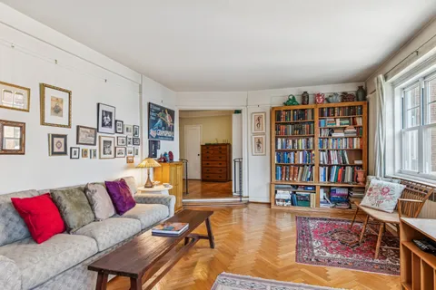 a living room with fireplace furniture and a book shelf