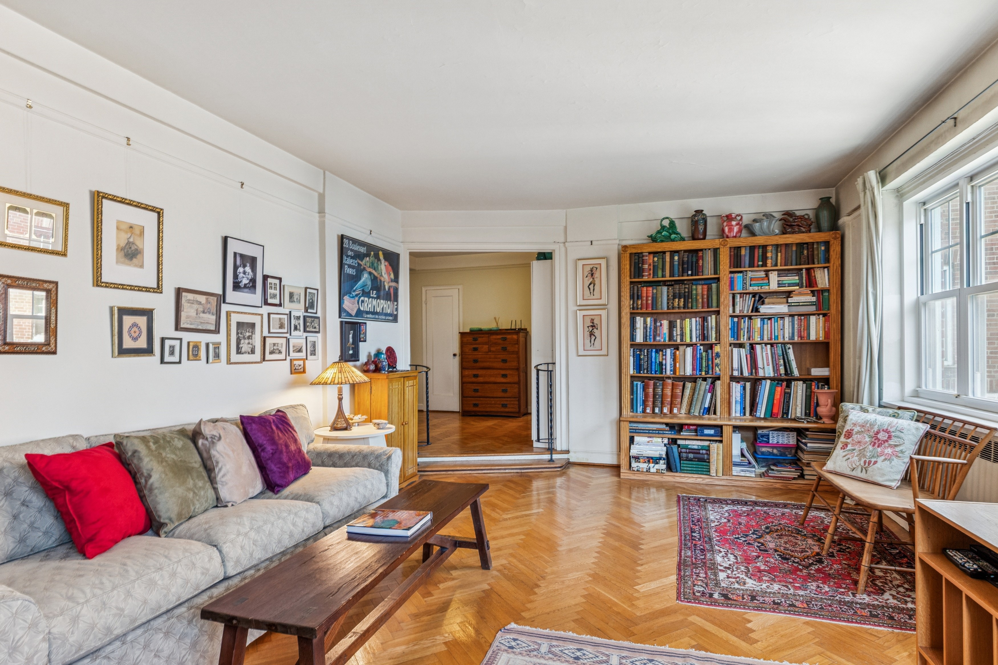 200 Cabrini Boulevard, Unit 47 Manhattan, NY 10033 - Photo 3 of 20 a living room with fireplace furniture and a book shelf