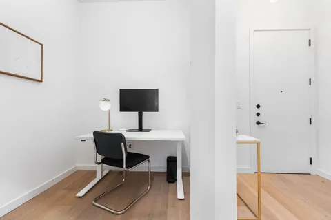 a work room with furniture and wooden floor