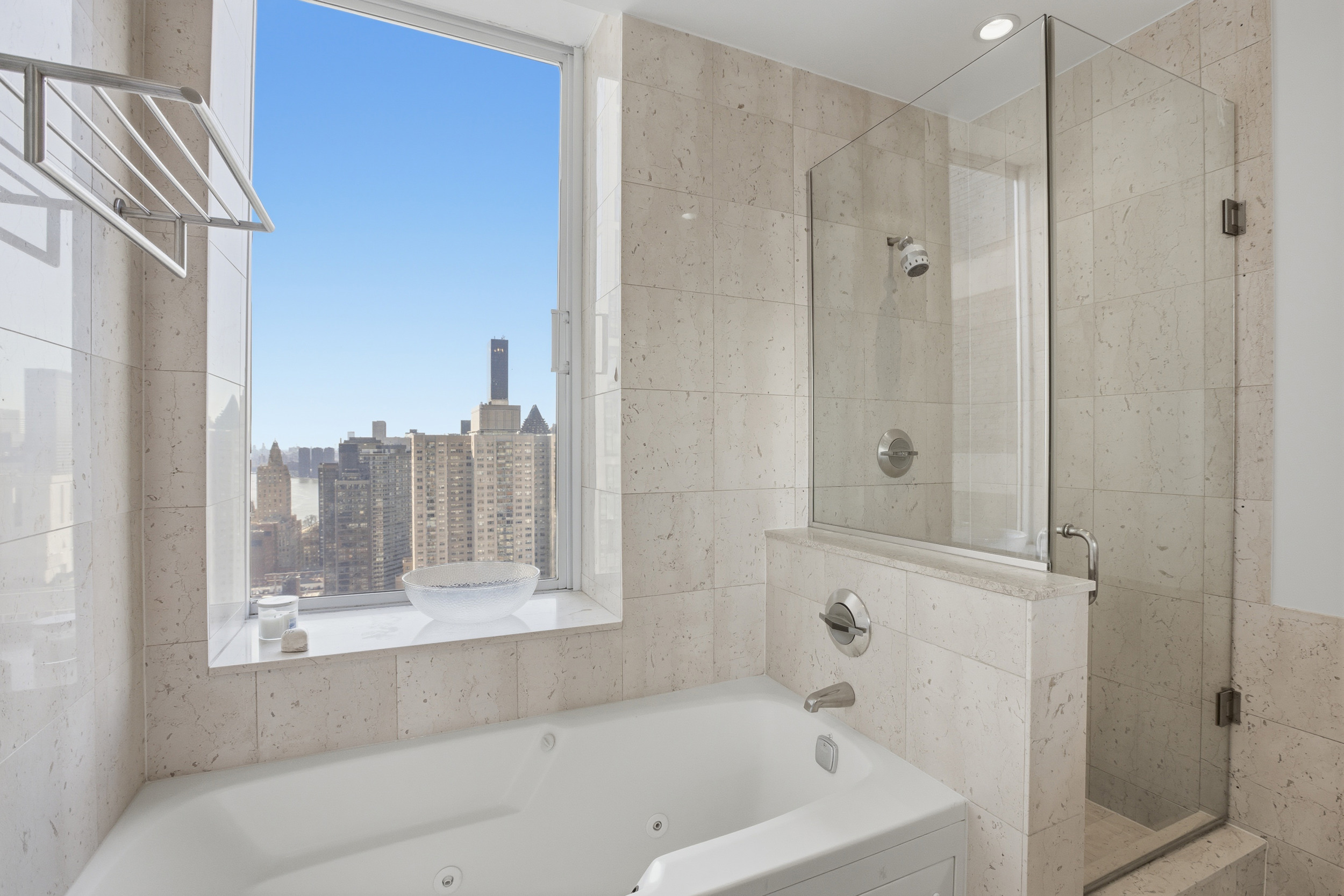 418 East 59th Street, Unit PHA Manhattan, NY 10022 - Photo 16 of 17 a bathroom with a bathtub and a shower