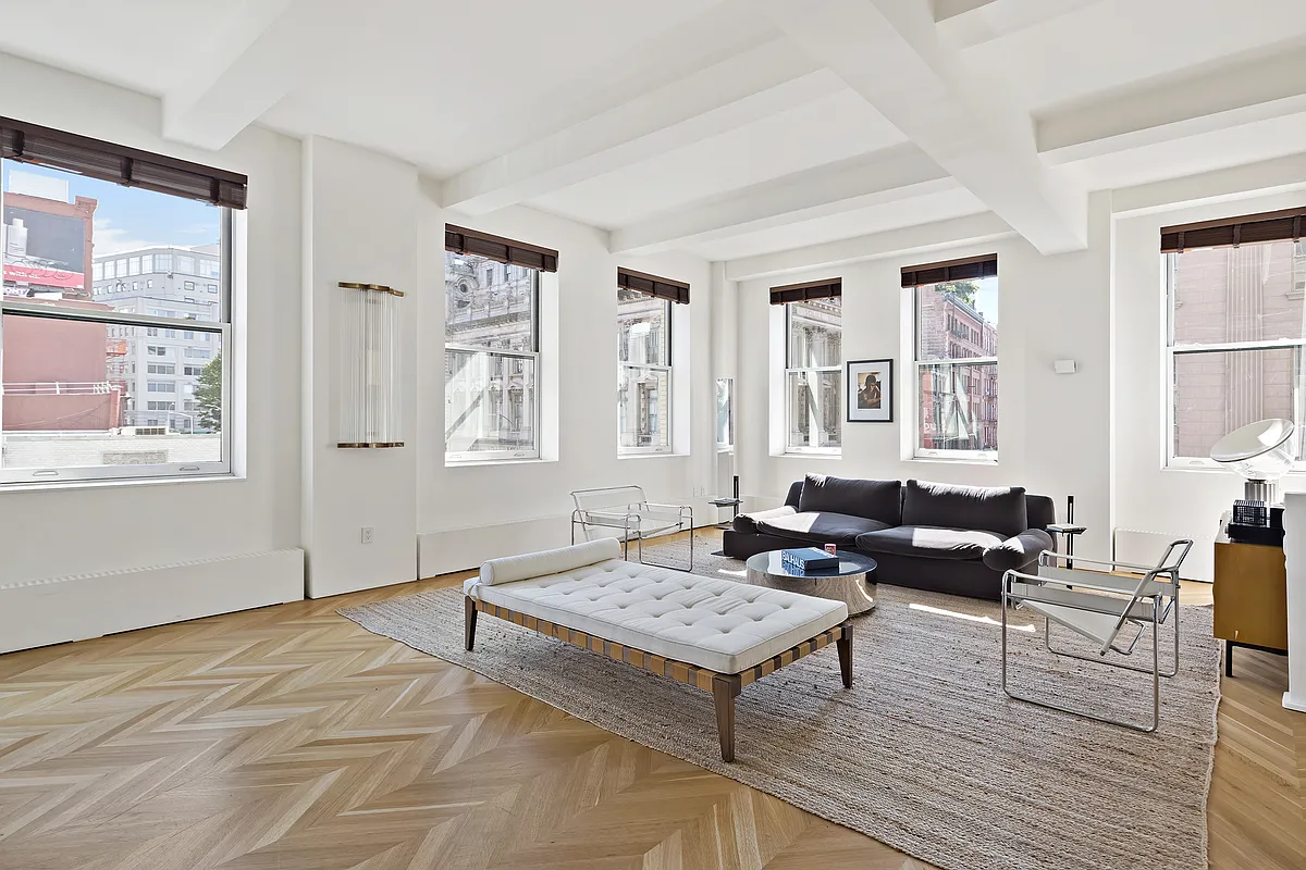 a living room with furniture and next to a window