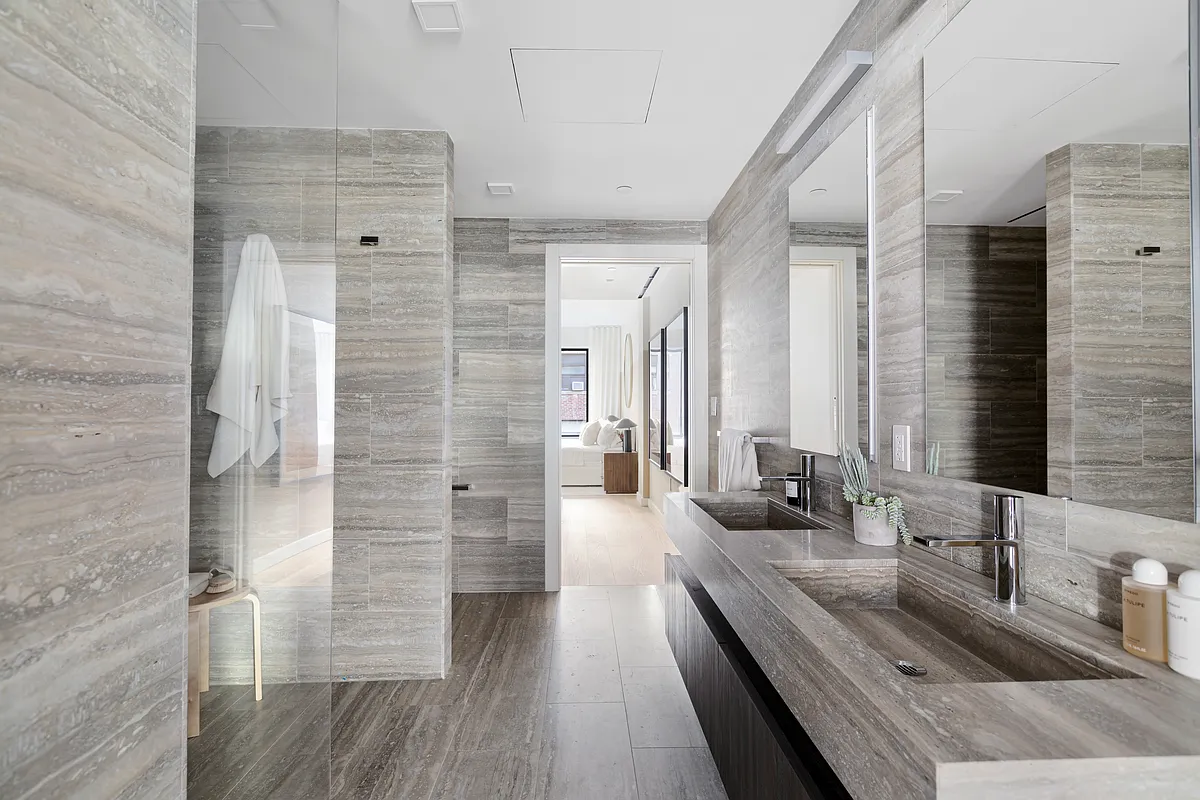 139 East 23rd Street, Unit 7 Manhattan, NY 10010 - Photo 10 of 17 a bathroom with a double vanity sink and a shower