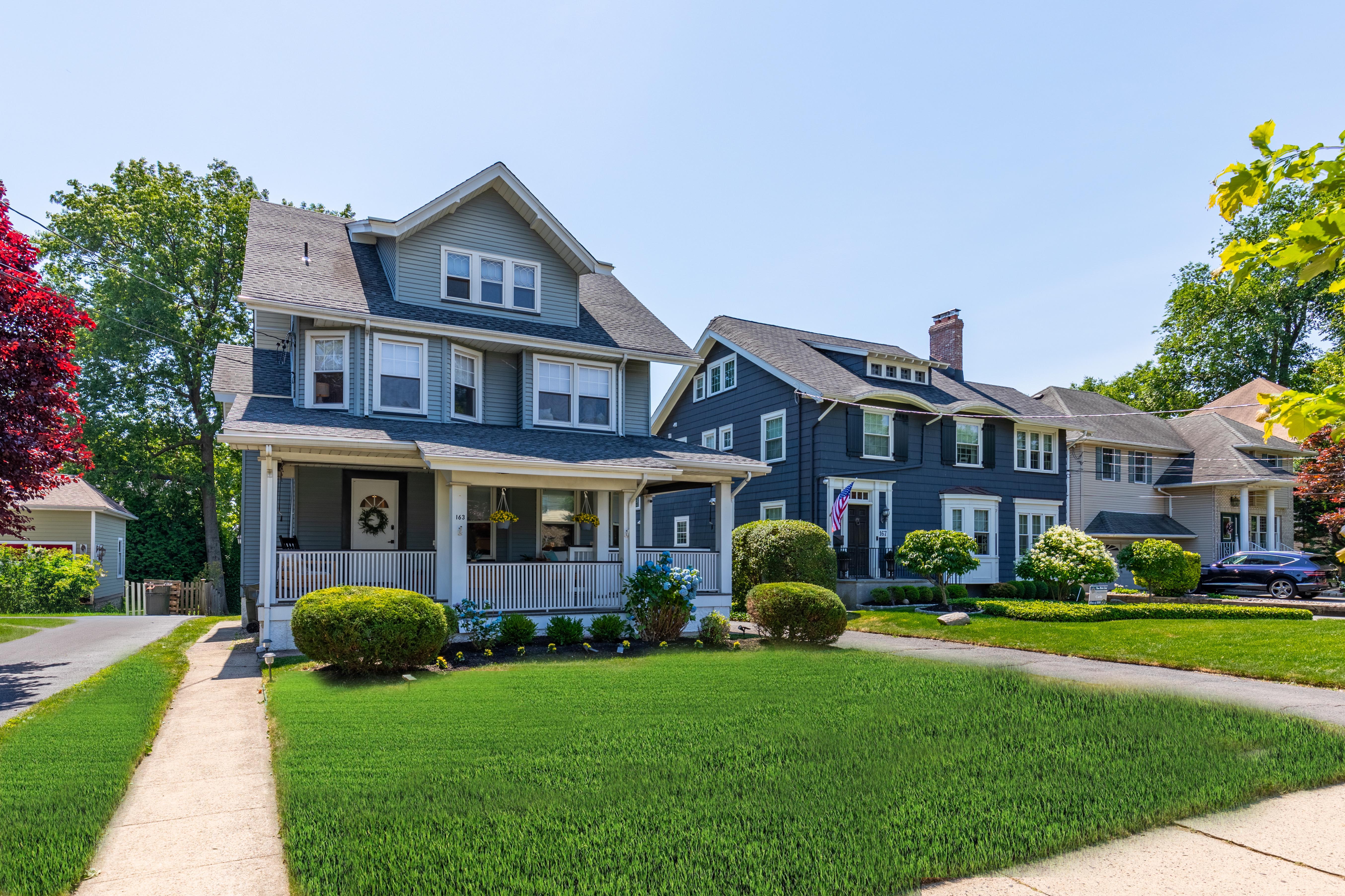 163 Ridge Road Rutherford, NJ 07070 - Photo 54 of 59 a front view of a house with a garden and plants