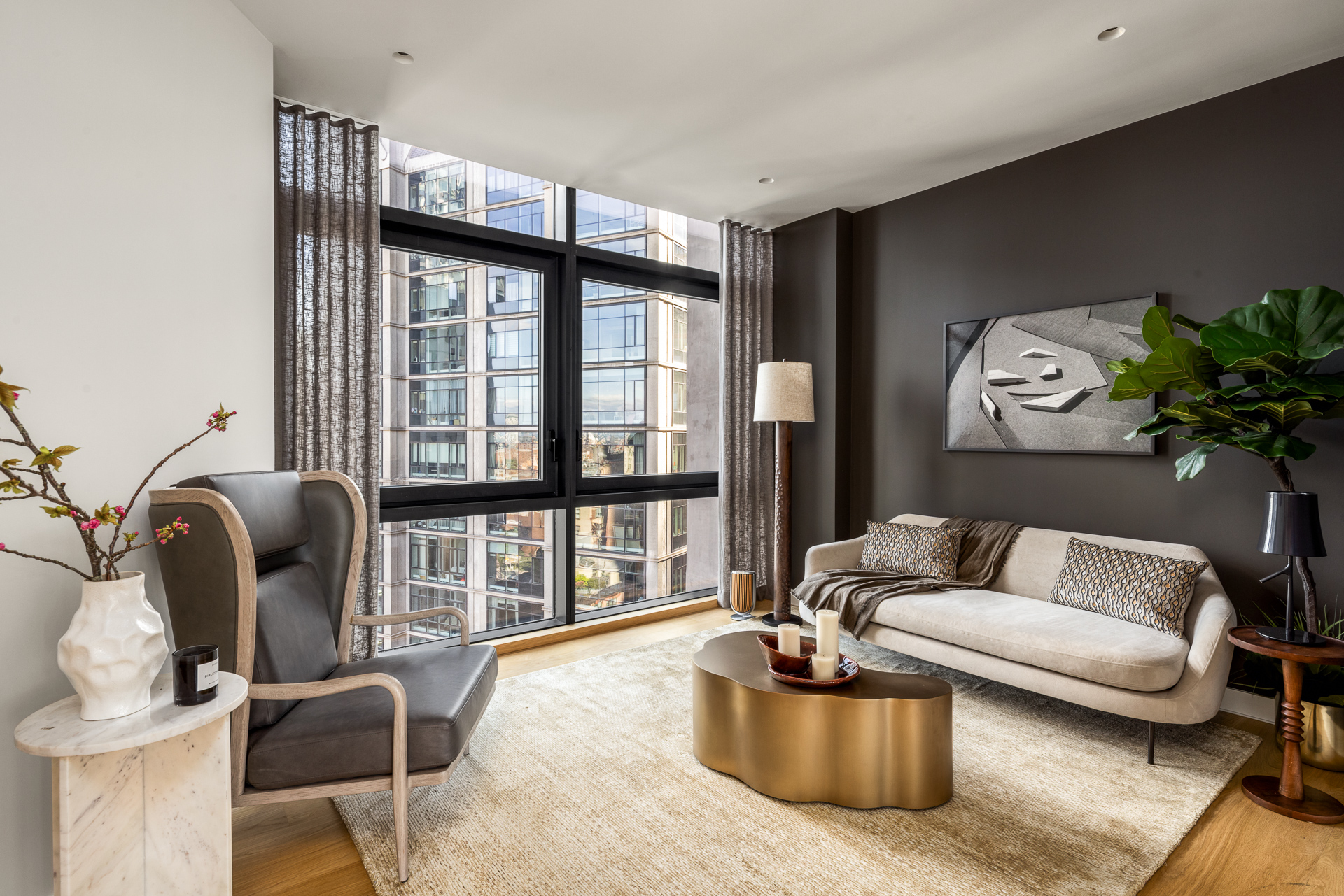 33 Park Row, Unit PH1 Manhattan, NY 10038 - Photo 12 of 15 a living room with furniture and a large window