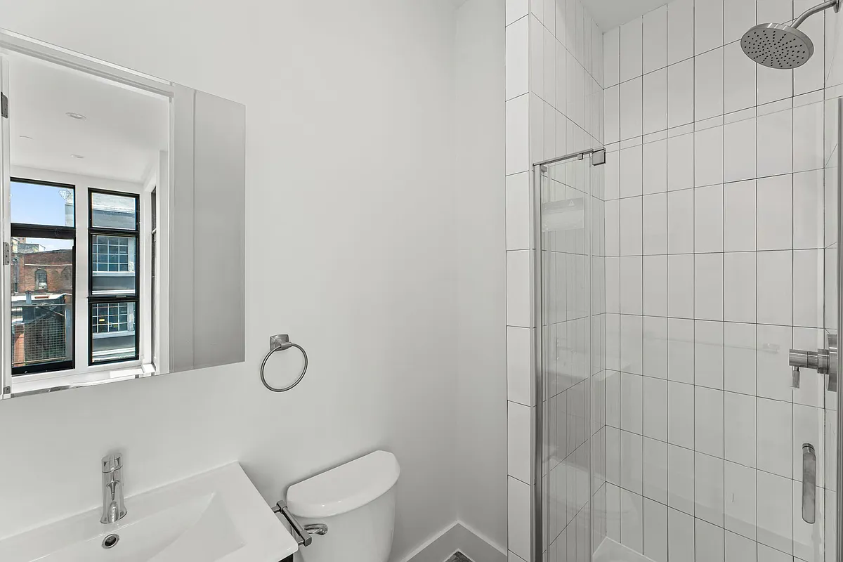 30 Belvidere Street, Unit PH4 Brooklyn, NY 11206 - Photo 6 of 8 a bathroom with a toilet sink and shower
