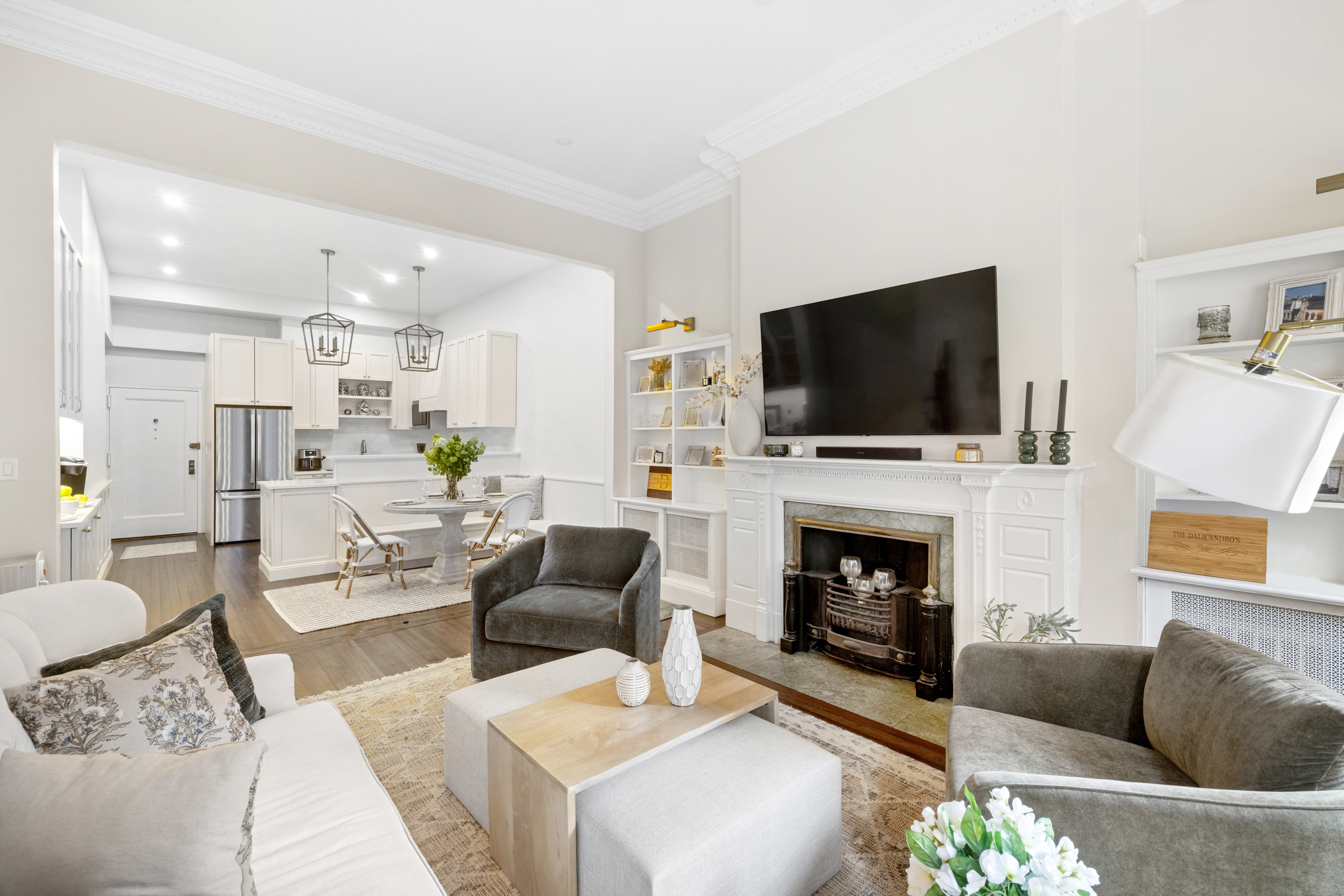 107 East 38th Street, Unit 2AB Manhattan, NY 10016 - Photo 4 of 13 a living room with furniture a fireplace and a flat screen tv