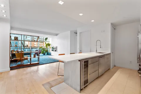 a view of a kitchen with a sink and living room