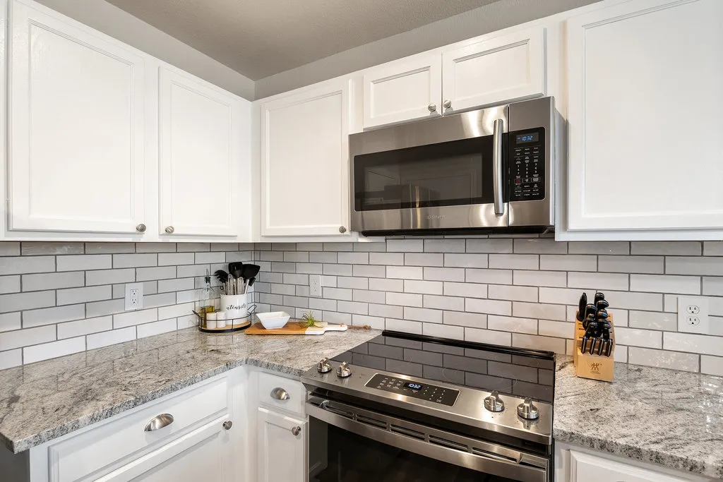 a kitchen with a sink stove and cabinets