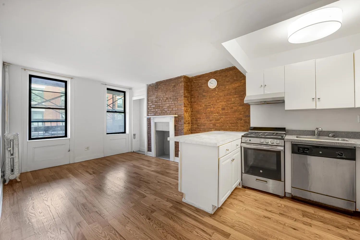 a kitchen with wooden floors and white appliances