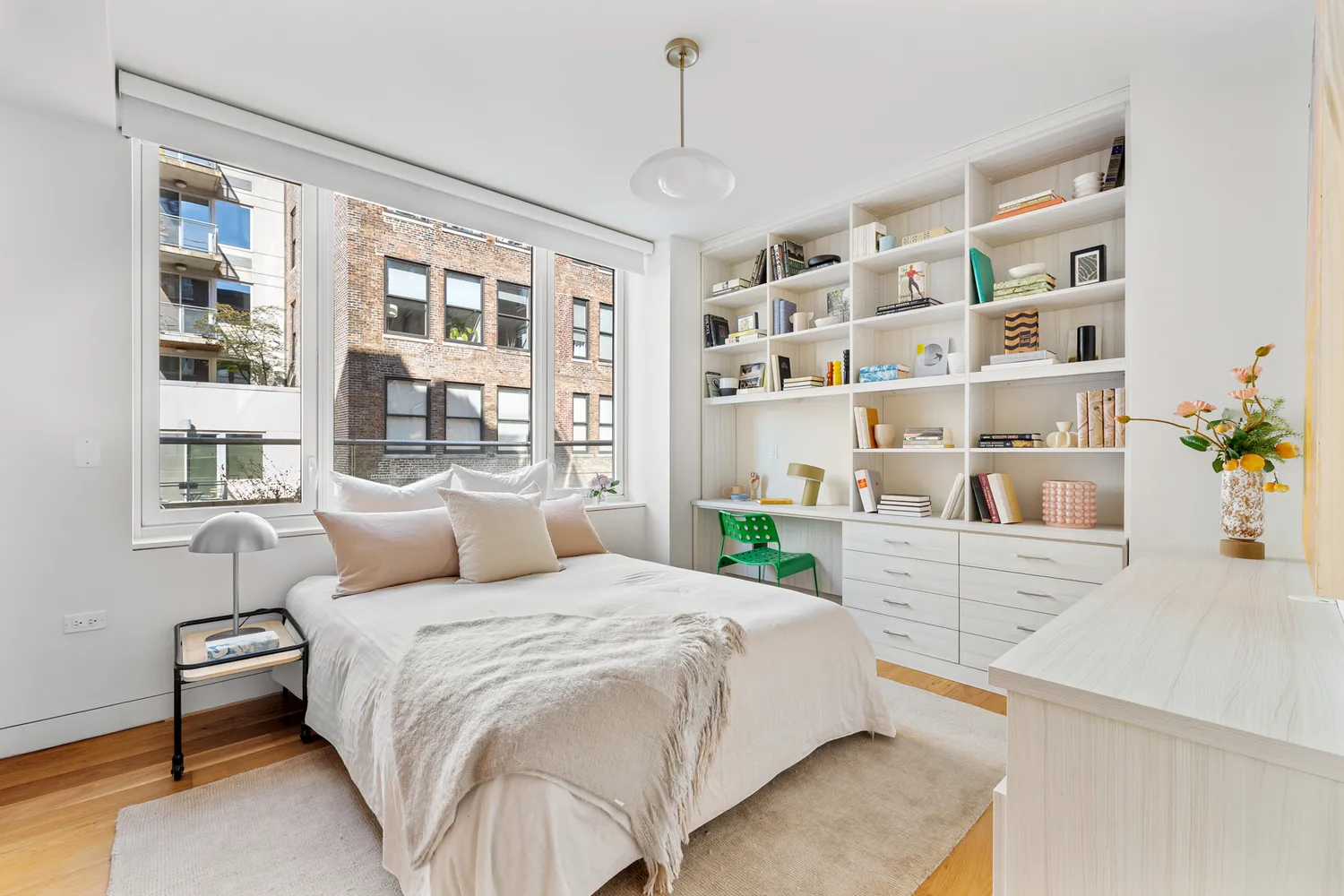 a bedroom with a large bed and a bookshelf