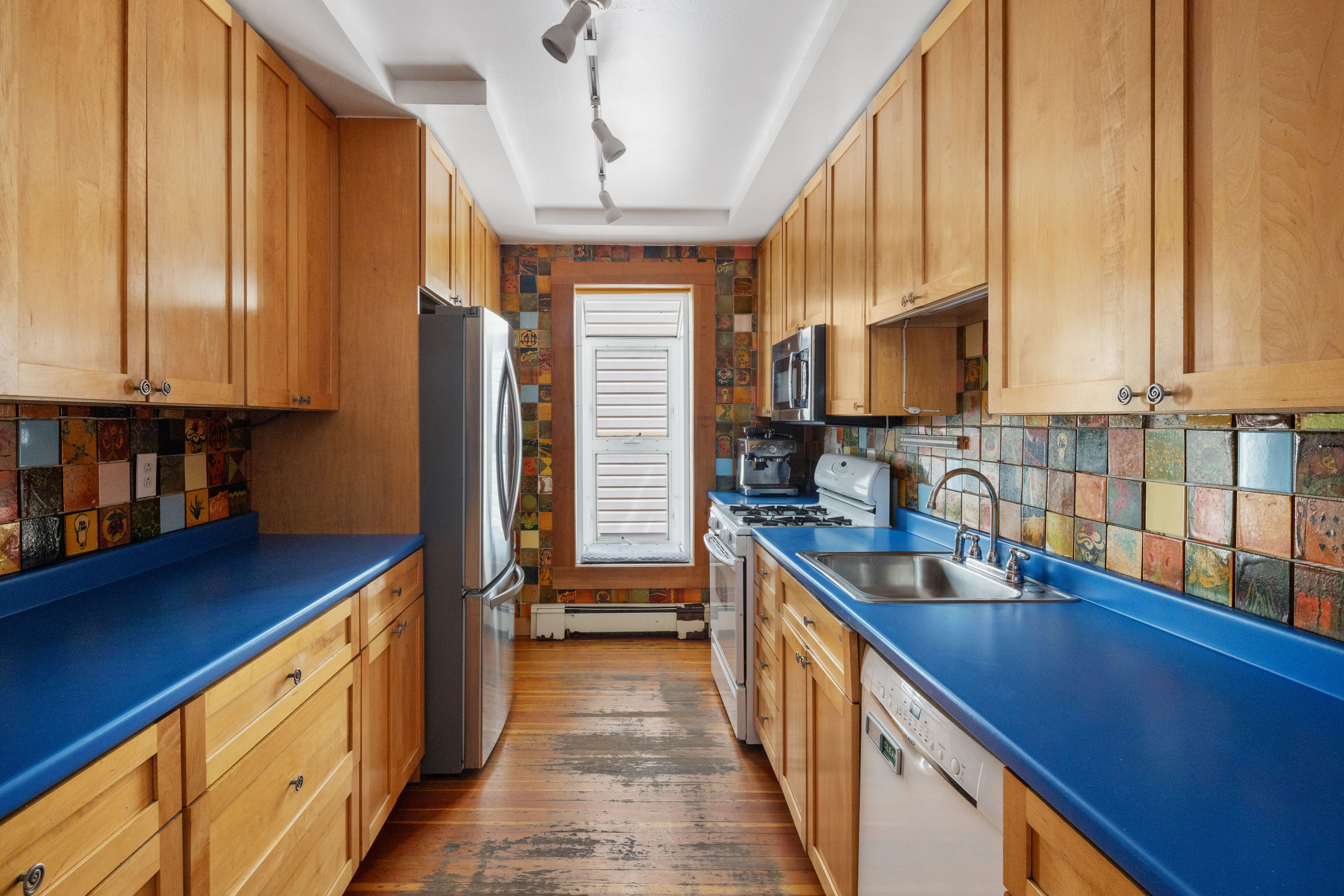 61 Norman Avenue Brooklyn, NY 11222 - Photo 8 of 22 a kitchen with stainless steel appliances granite countertop a sink a stove and a wooden cabinets