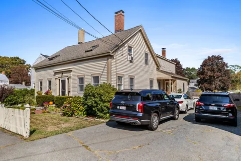 a view of a car parked in front of a house