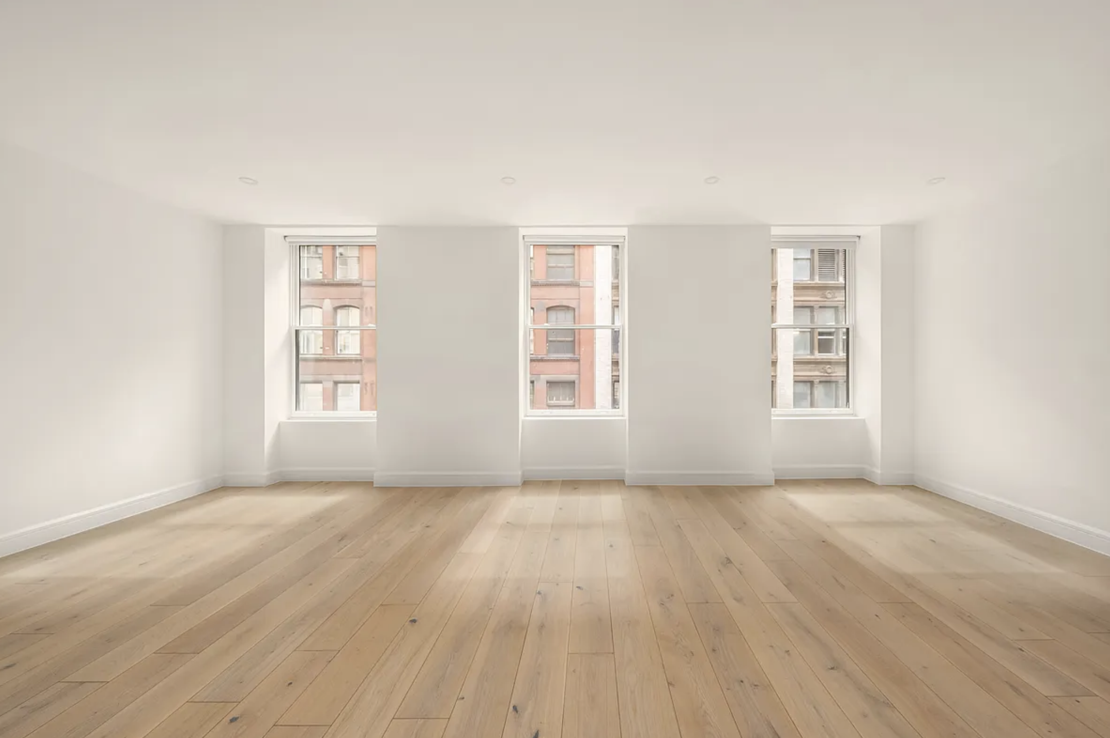 17 West 24th Street, Unit 4 Manhattan, NY 10010 - Photo 1 of 8 a view of an empty room with wooden floor and a window
