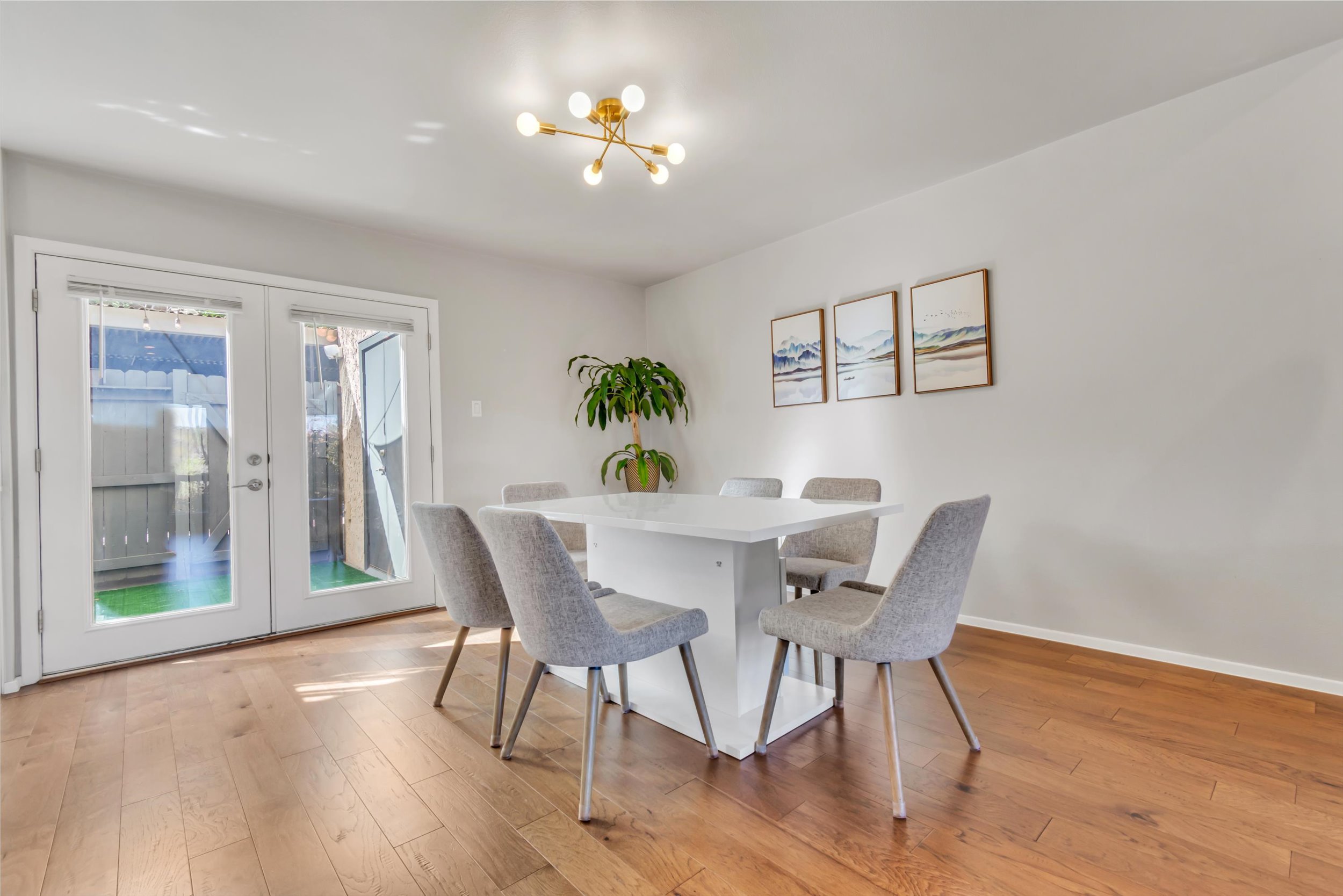 3601 Las Colinas Drive, Unit C Austin, TX 78731 - Photo 17 of 33 a view of a dining room with furniture wooden floor and a chandelier
