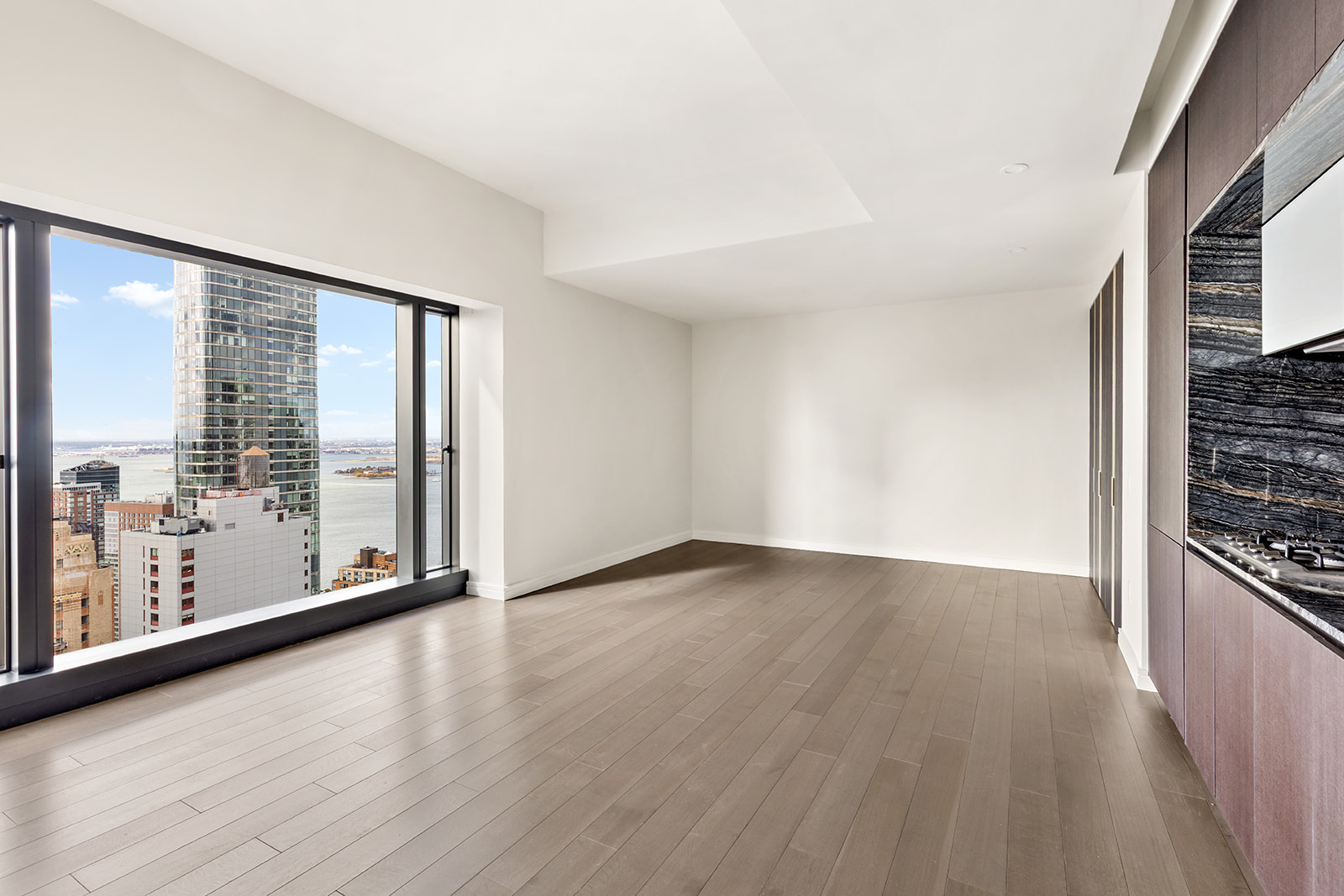 125 Greenwich Street, Unit 61C Manhattan, NY 10006 - Photo 2 of 16 wooden floor in an empty room with a window
