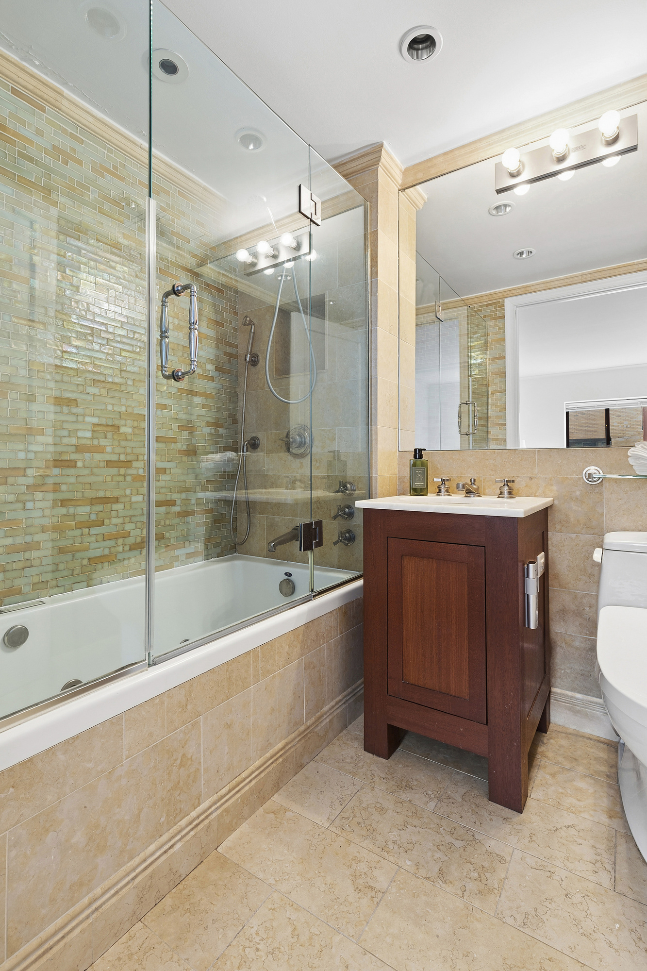 217 East 7th Street, Unit 5CD Manhattan, NY 10009 - Photo 7 of 11 a bathroom with a bathtub sink and mirror