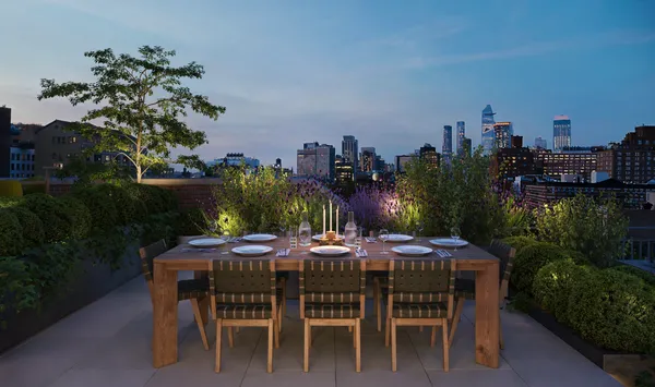 a patio with a table and chairs and potted plants
