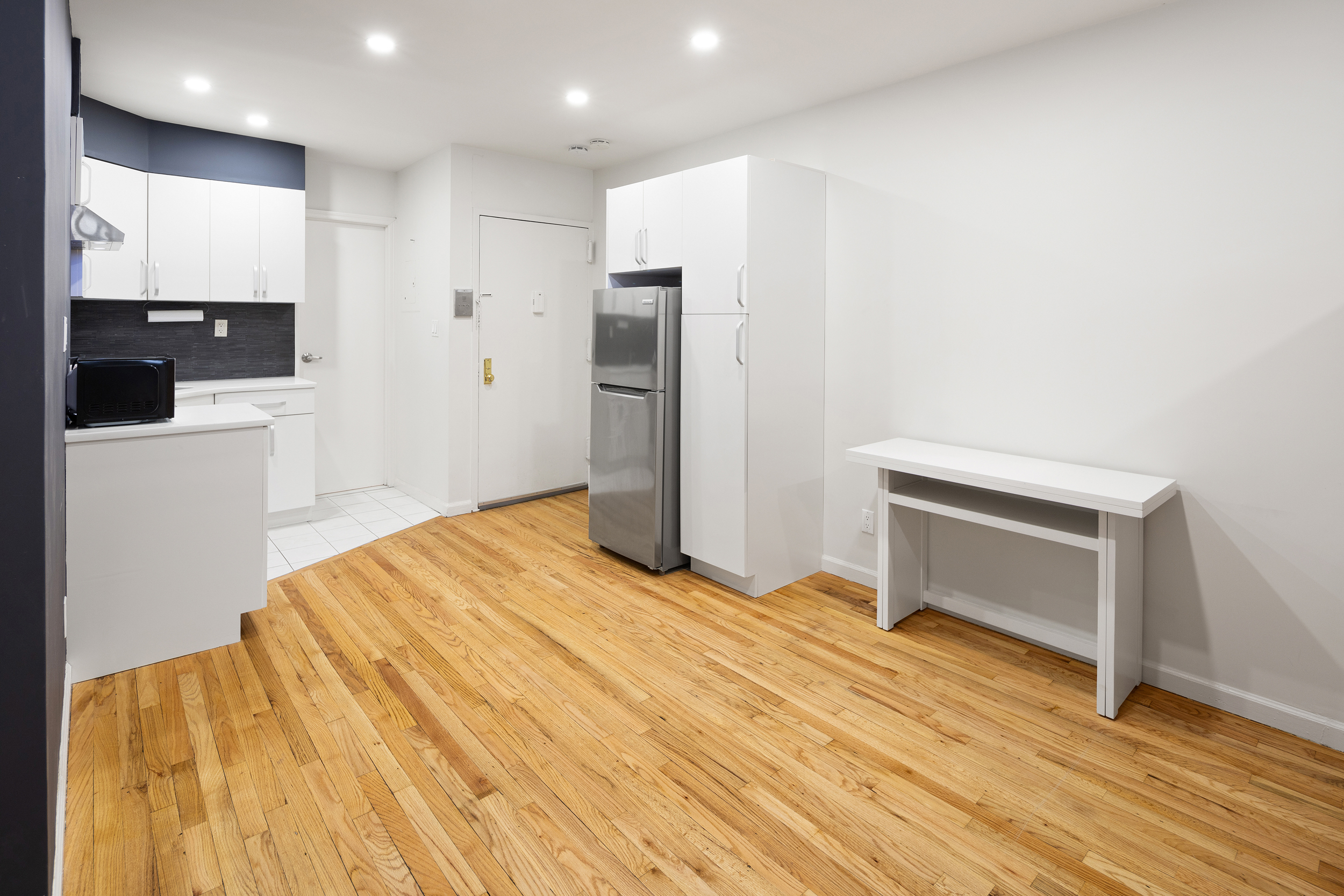 101 Allen Street, Unit 3A Manhattan, NY 10002 - Photo 3 of 5 a bedroom with a bed and a television